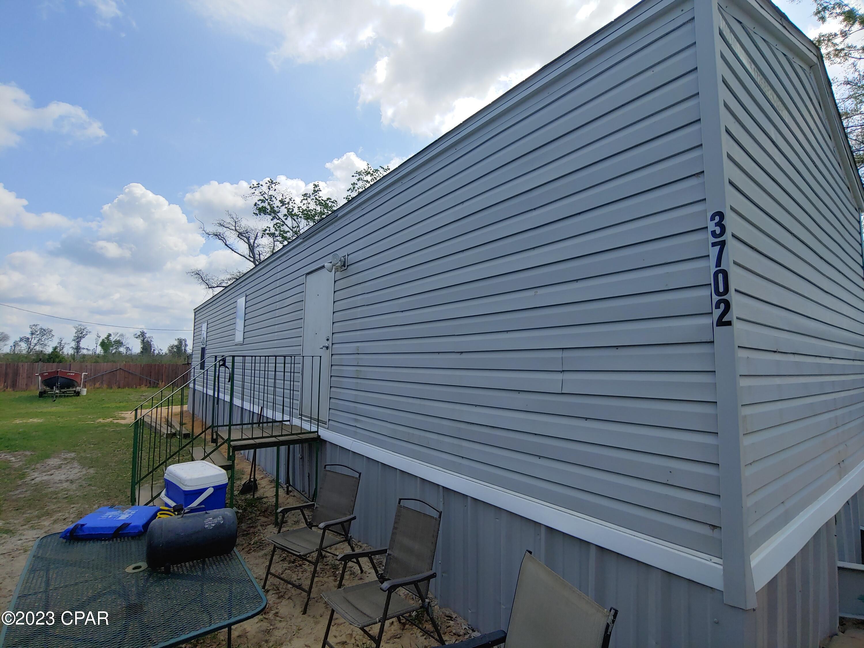 Check out this newer home on newly paved road with huge yard! Large 18' x 24' workshop and shed included. Additional power pole on site for RV, Boats, or other uses. 



Home has extra features such as extra wide entry and interior doors, grab bars in shower and bathroom. Well built 2x6 Construction with insulation upgrade. Factory installed fire alarm and sprinkler system. Wind Zone 3 Rating!



Workshop has power, with a laundry area, separate rooms for storage, and a finished room. 



Only 15 Minutes to Downtown Panama City or Tyndall Air Force Base, 20 Minutes to Panama City Beach. 



Additional structure on site is an older mobile with Porch. Not currently connected to power, water, or septic.