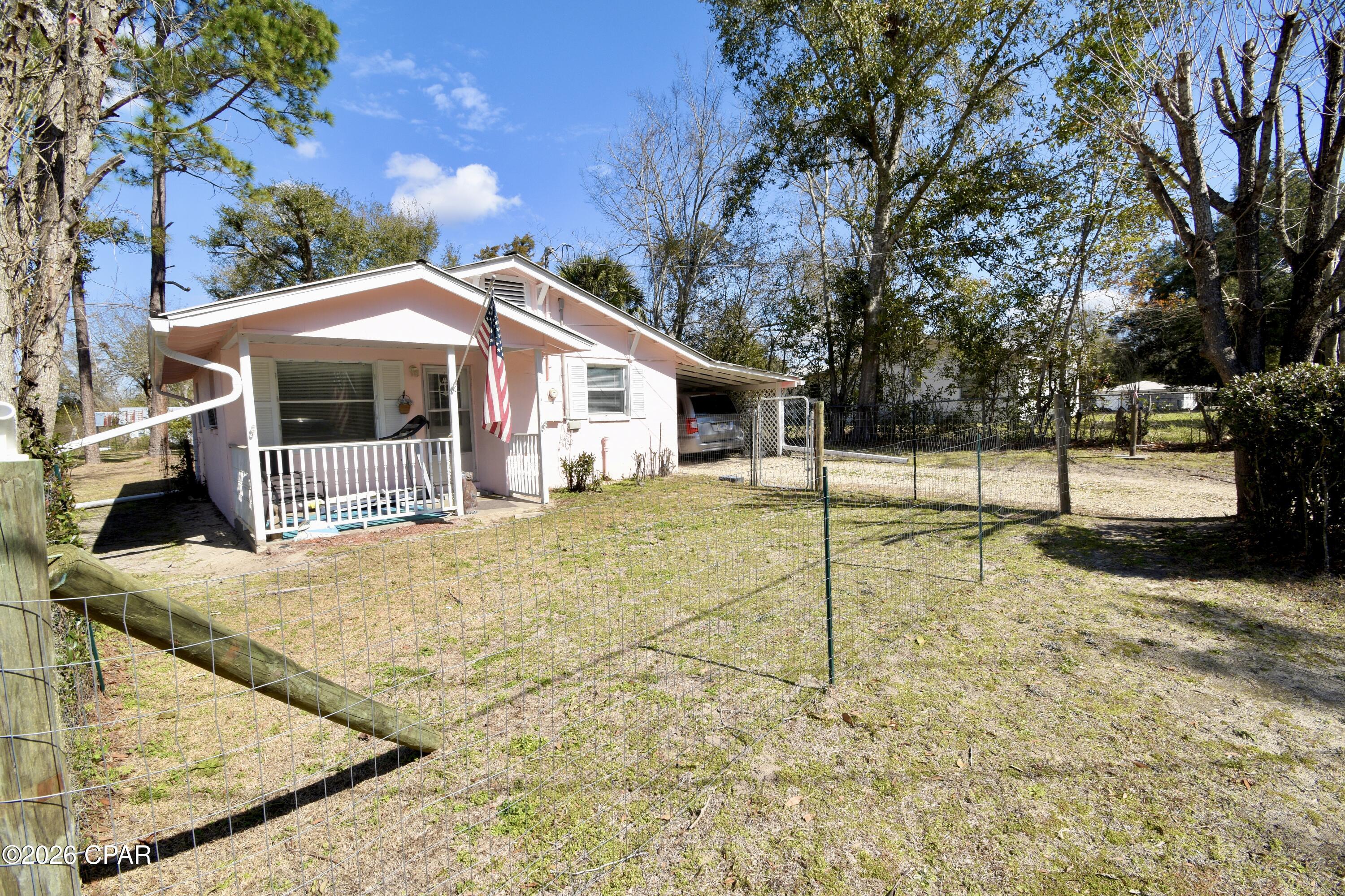 Tired of the cold winters up North or the crazy hustle and bustle of South Florida? A tiny home in a tiny panhandle town could be just what you need! 

This adorable Florida cottage in the city limits of Cottondale has 1 bedroom, 1 bathroom, and an extra room that works well as a storage space, pantry, small office, or nursery. You also have a walk in shower in the spacious bathroom with room for storage shelving. The kitchen has stainless steel appliances.

A rock driveway leads under the attached carport, and there's an outbuilding in the back that includes storage and a laundry area with a washer and dryer. Heating and air conditioning is via window units/space heaters. Public sewer/water/garbage are the utilities.

The backyard is large, fenced, and well kept, with recently trimmed trees. A covered front porch is the perfect place to relax and look at your fenced front yard. 

The property sits on multiple lots on a corner parcel- possibility of separating the back lot for another parcel (buyer to verify with city if important). The home is concrete block construction on a slab with a metal roof- the perfect style of construction for Florida! It's move-in ready and partially furnished.

Located just off Highway 231, it's about a 30-minute drive to Dothan and a little over an hour to Panama City Beach. You are also conveniently located just off of Hwy 90 between Chipley and Marianna.15 minutes to Walmart in either direction and 4 miles to I-10!

This home would work well for a starter home, retirement place, rental, or Airbnb. It's a simple, affordable cottage in a quiet Panhandle town--practical, easy to maintain, and easy to live in.

There is an active termite Bond on the home through Cross Country & a survey available!

Housekeeping and lawn service available! 

The seller is accepting cash or conventional financing (no USDA, VA, or FHA).