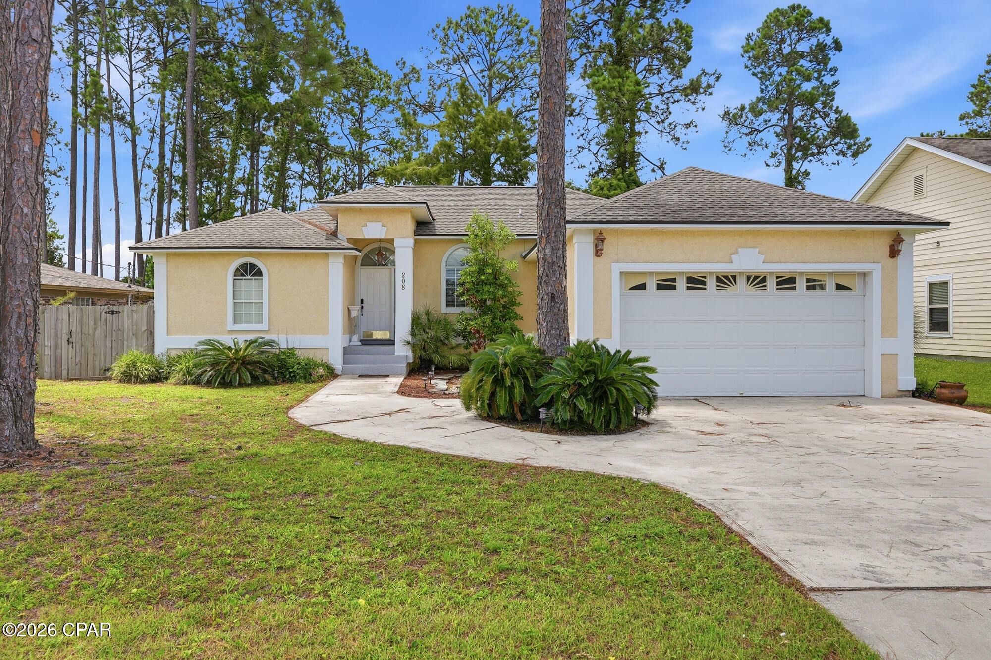 Welcome to 208 Palm Circle! This ONE LEVEL 3-bedroom, 2-bath home offers 1,756 square feet of comfortable living, large backyard and an attached 2-car garage in a prime Panama City Beach location. Enjoy a newer roof, and spacious interiors with inviting living areas and generously sized bedrooms. Situated adjacent to Scott Field Park, you'll have convenient access to green space, playgrounds, walking paths, and recreational amenities. Just minutes from public beach accesses, Pier Park, Frank Brown Park, shopping, dining, and entertainment, this home offers the perfect blend of comfort and convenience for a primary residence, vacation home, or investment property.