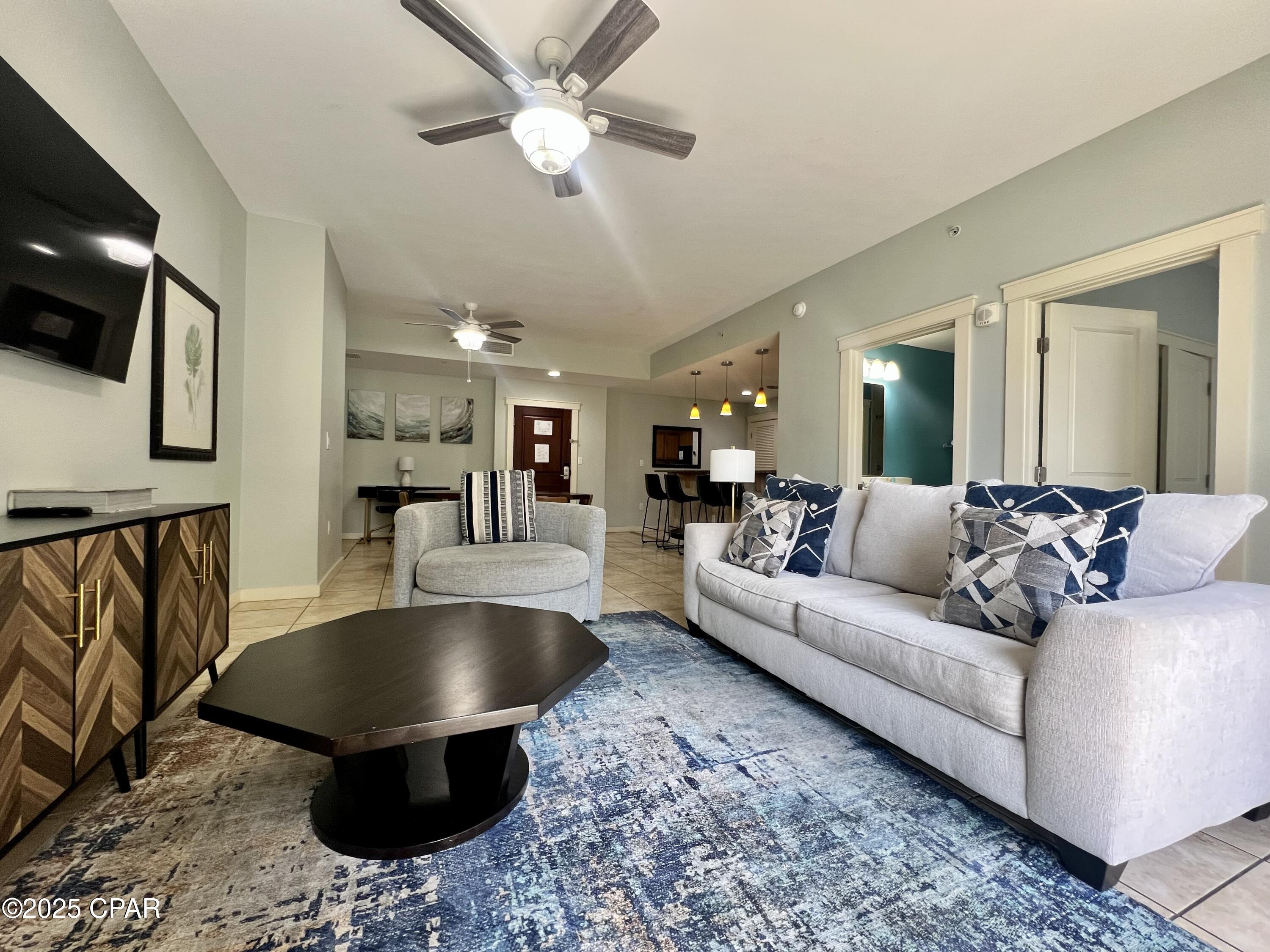 This spacious 2 bed 2 bath condo overlooking the Gulf, white sugar sands, and the pool deck at Origin is ready for a new owner.  Unit 1408 has been renovated with new paint, fans, furniture, and decor.  Thoughtfully finished and being sold fully furnished.  Once through the sold wood entry door, there is a large kitchen with a new refrigerator, black appliances, and tile floors.  A bar top for 4, and a mid-century dining table for 6 will keep your guests together and close to the kitchen for those meals in, or family game night.  There is even a desk next to the dining area that provides a nice workspace.  The large living room offers plenty of seating, and a sleeper sofa for additional heads in beds.  The split floorplan gives plenty of privacy with the guest bedroom opposite the primary bedroom, and a guest bath that opens to the living area and bedroom.  The primary bedroom is absolutely huge!  There are 2 closets (one that is currently being used as an owner's lock closet), a large hallway, room for a sitting area, an attached full bath, and a sliding patio door with access to the oversized balcony.  Both bedrooms have king sized beds and stunning Gulf views.  No carpet in the entire unit!  Both bedrooms have luxury vinyl plank flooring, and all other area have ceramic tile.  Once through the sliding glass door in the living room, or bedroom, you step onto your private balcony overlooking the beach, Gulf, and pool deck.  Unit 1408 is one of only two condos with this floorplan at Origin that has an oversized balcony with a walkthrough to the living area and primary bedroom.  The patio furniture has recently been upgraded to a composite tall top table with 2 chairs and 2 Adirondack chairs with a side table that will last for many years to come.  At 1293 square feet inside, and the large balcony, you will have plenty of room for all your guests!  Origin offers many amenities including two BBQ grill/picnic areas, a heated pool, hot tub, theater, game room, laundry facility, vending, a gated community with 24-hour security, Beaches and Cream convenient store and grill, and a Sunsations beach store located on the ground level. Origin is also one of the only high-rise condos on the beach that offers interior corridors that will keep you out of any inclement weather.  The sellers are motivated to see their home away from home go to a new owner that will love it the way they have.  Give me a call today to schedule your private viewing and make this space your slice of paradise!