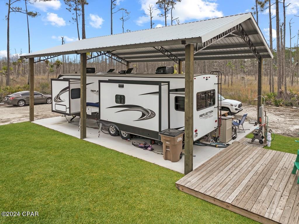 Exceptional 1/2 Acre RV Lot with Panoramic Bay Views, Sturdy Pole Barn, and New Shed with Washer and Dryer, Just Moments from the Tranquil Beaches of Cape San Blas! This outstanding property, featuring a generous half-acre size, offers an unparalleled bay view, providing the perfect canvas for your dream escape. Complete with essential utilities and secure covered parking, this is the opportunity you've long been anticipating. Enclosed for maximum privacy, relish in the serene water vistas stretching across St. Joseph Bay, while indulging in breathtaking sunsets from your exclusive deck. The proximity to pet-friendly beaches and the Gulf of Mexico, coupled with convenient access to the community boat ramp, ensures endless aquatic adventures. Whether you prefer fishing along the shoreline or embarking on a scenic bike ride along miles of paved nature trails, this location caters to your outdoor pursuits. Salinas Park, a family-friendly haven, awaits nearby, offering kayaking, horseback riding, pickleball courts, and more. Additionally, the property boasts a new shed, equipped with a washer and dryer, providing added convenience and functionality to your coastal retreat. Seize the chance to transform this into your idyllic getaway, where every day is a retreat. Act swiftly, as opportunities like these are not to be missed!