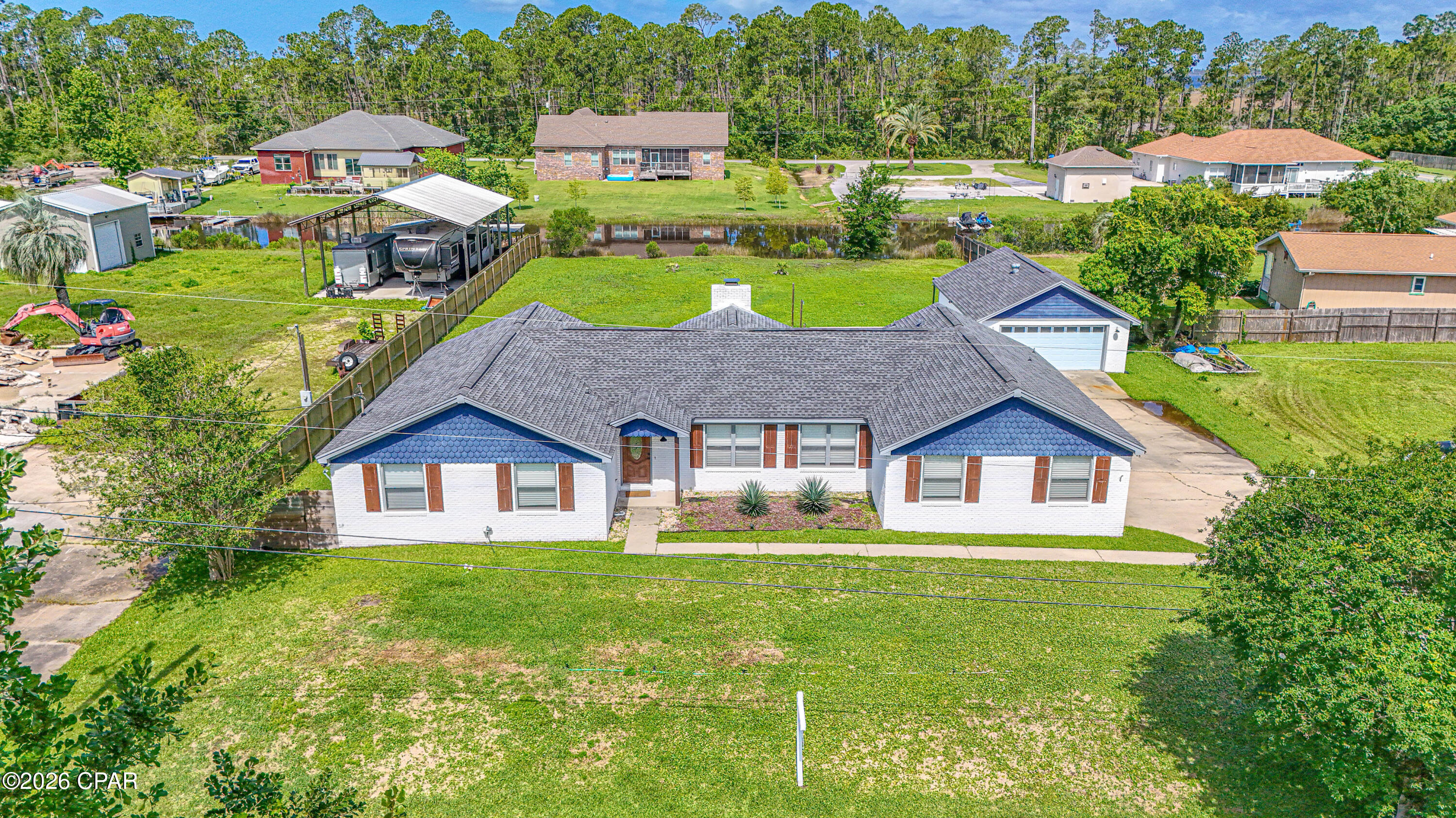 Price adjustment and OPEN HOUSE SUNDAY 1 TO 3 P.M.  This is a must-see home with Lynn Haven location in Northshore. This large remodeled home with 2364 sq. ft. of living space is located on over half an acre with a peaceful canal view. This well-designed property offers an open and versatile floor plan with  3-bedrooms 2.5  bathrooms with a bonus room that could be a 4th bedroom,  office, gym, media room or playroom. This home has been  remodeled and offers a large master suite with large bathroom  with double vanity, with a walk in shower. The bedroom opens up to large back yard overlooking a canal. The Kitchen has butcher block counter tops, new cabinets and opens to large great room with fireplace and french doors leading to a large backyard. There is a large detached garage or workshop with storage space and plenty of room to park your boat on this lot. New Septic Tank in 2025.  Ideal for those looking for extra space, functionality and a peaceful backyard with a water view.  Make your appointment to see this beautiful, spacious home.  Seller says she is motivated!!
