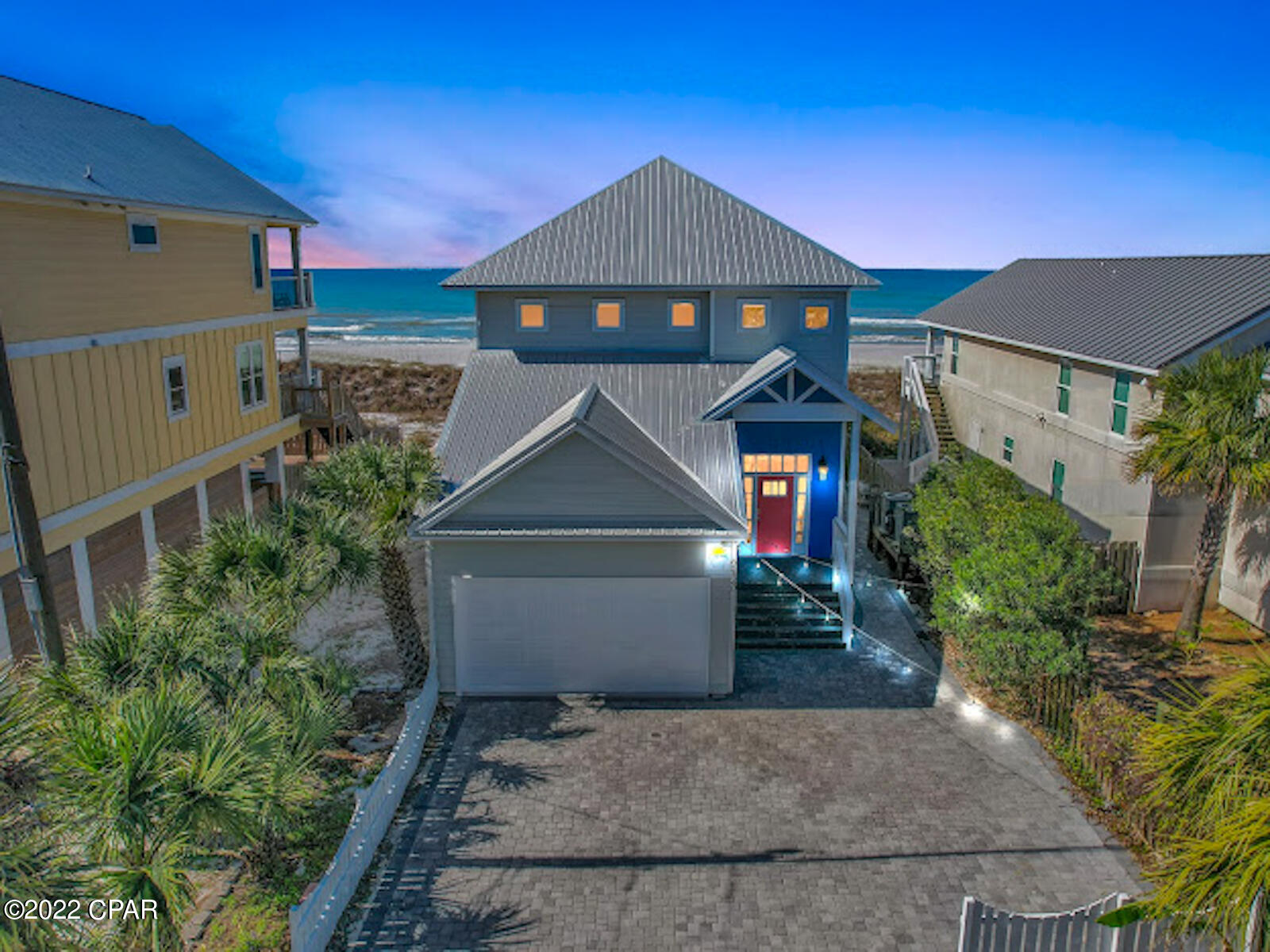 CURRENTLY UNDER CONTRACT; SELLER ACCEPTING BACKUP OFFERS

RENTAL HISTORY OF $180K+ in 2021***** Coined ''Peach on the Beach'' due to its charm and likeably, this spectacular waterfront Beach home has unobstructed, panoramic views of the Gulf of Mexico.  With 4 bedrooms, 4 bathrooms, and 3 separate entertainment spaces, this popular vacation rental is ideal for the vacationer seeking privacy, comfort, recreation, as well as leisure.  Want to have a beach day? Exit through the back French Doors on the first floor, take the newly installed exclusive, private beach walkover, and you are just a few steps away from the crystal white sands of Panama City Beach.   Want to stay in? Enjoy the swim-spa on the back deck or cozy up next to the fireplace with a great book.  Want more entertainment space? Head to the fully heated and cooled recreational room for a game of ping-pong, darts, and foosball or rest on the couch while watching your favorite sports team. This additional space is also ideal for accommodating large groups with children.  The beautifully designed kitchen is open to the main living area and features white custom cabinetry, blue arabesque backsplash, granite counter tops, microwave/oven combo and gas stove. This beach house can sleep up to 16 guests comfortably and features 2 bedrooms and 2 bathrooms downstairs and an additional 2 bedrooms and 2 bathrooms upstairs. The oversized custom paver driveway is perfect for accommodating several vehicles.  Head upstairs and you will find another living area known as the bunk room featuring additional space for guests and a wet bar with a mini refrigerator.  Take in the waterfront views from the private master suite upstairs featuring a large walk-in closet as well as French Doors leading out to the upper balcony.  The master spa is spacious and features a double vanity, garden tub, and white subway tiled shower.   A new roof was installed in 2016 and the exterior of the home was remodeled in 2019.  "Peach on the Beach" is located in Flood "X" which does not require flood insurance; however, the current owner does have an affordable flood insurance policy that is fully transferrable.  There is also no HOA which means no frivolous HOA fees! Schedule your private viewing today to enjoy this delightfully decorated beach house and the picturesque landscape.