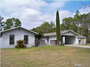 Enjoy quite country living close to town. Well Built Concrete Block Home (with Stucco Exterior) offers 2 Bonus Rooms which could easily make the house a 5 BR. All the extras like an in ground 36' kidney-shaped gunite pool just outside the Master Bedroom. The Home is styled in a unique floor plan offering an exterior door to the outside from almost every room. Lovely Courtyard at front entrance of home as well as a nice foyer at entry. Spacious 3.1 acre parcel has small pond with a wonderful nature trail around it. Some of the property remains wooded giving refuge to many forms of natural habitat and wildlife. Detached Double car Garage with Workspace, Plus a Double Covered Carport under Roof of Home. Open & Airy kitchen features Whitewash cabinets & Pantry Closet. Large Family room