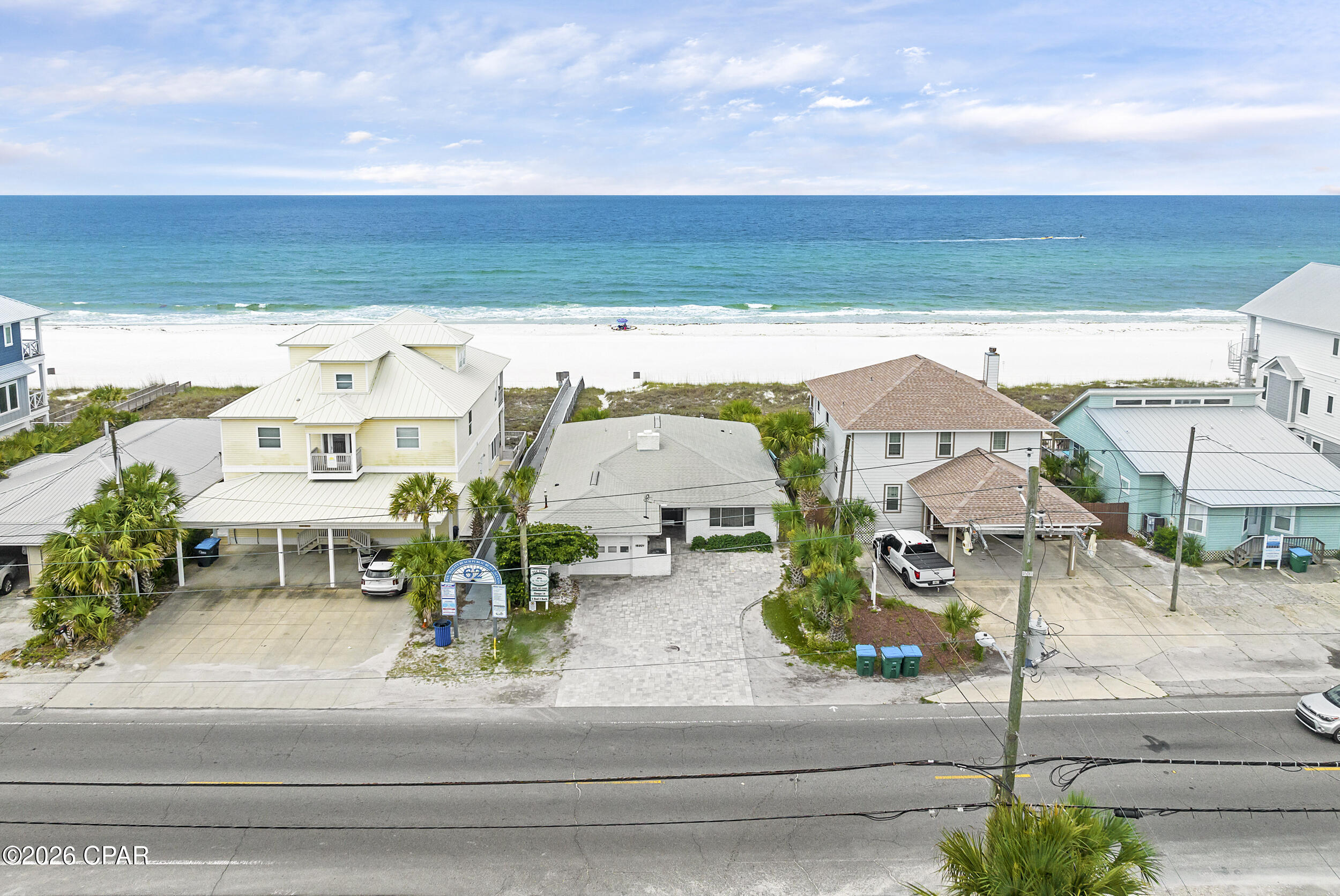 This all-brick, gulf-front home sits on 50 feet of open beach frontage at the heart of Panama City Beach, steps from Pier Park and directly on the sand. No high-rise above it. No HOA below it. Just a wide wooden deck, a short path, and the Gulf of Mexico.
A 1,200 sq ft deck spans the full width of the home -- nearly all of it just updated -- built around what actually matters here: the view, the breeze, and the kind of Florida weather that keeps you outside most of the year. Mornings start with coffee and soft light over the water. Afternoons settle into open space and steady salt air. Evenings stretch into wide, unobstructed sunsets that run clean across the horizon.
Inside, a full wall of newly installed, impact-rated hurricane glass opens the main living area to constant water views while delivering the kind of storm protection that matters on the Gulf. Tile floors throughout keep things low-maintenance after time on the sand. A white brick fireplace handles the cooler months. The gulf-front primary suite opens directly to the deck -- mornings start without transition.
Five bedrooms and three bathrooms allow the home to comfortably accommodate extended stays, larger groups, or consistent vacation rental use. The property is currently operating as a successful short-term rental. A brick-paved driveway provides parking for three vehicles. No HOA means full flexibility in how the property is used.
Brick construction is a rarity on the Gulf. What was built to last has lasted -- and in a market where gulf-front lots are essentially gone, the land itself carries weight. Direct beach frontage at this location, no HOA, no deed restrictions -- the kind of position that's worth holding regardless of what sits on it. Whether the play is enjoy it now, rent it, or eventually redevelop, the optionality here is real.
Pier Park, Russell Fields Pier, Dusty's Oyster Bar, and McGuire's are all within minutes. This is as centrally located as beachfront gets in PCB.
Schedule a private showing.