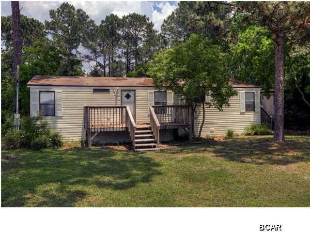 3BR/2BA double-wide mobile home with new paint, new laminate flooring, new vanities with marble counter tops and new ceramic tile in bathrooms PLUS new HVAC in 2011! Also includes a new washer/dryer and refrigerator. There is a fireplace in the living room with blowers. Located 3 blocks back from the beach on a large lot with a storage building in the back. Home is in the ''X'' flood zone and does not require flood insurance.
