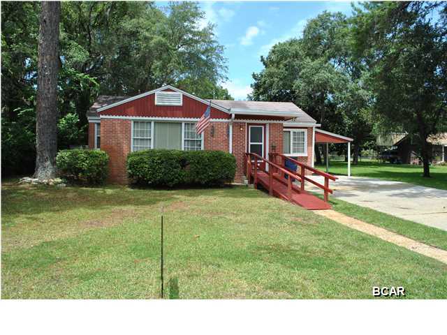 House has a large wooden handicapped ramp at the front door, as well as one internal ramp to assist going from the front area into the living room. Master bath has well placed safety bars. This 3 bedroom, 2 and one half bath home has the bedrooms split. The den could be used as a small bedroom for a half bath and small closet is adjacent. There are many built-in shelves and ledges throughout this unique ''Cove'' home. The kitchen is at the rear of the home, away from the bedrooms. The unattached workshop/storage building in the back yard is unique with its block walls and concrete roof. The rear of the property, outside the lockable fence, is in contact with a public alley. This home has been maintained very well and is being sold ''AS IS''. Due to the need for a wiring upgrade, th