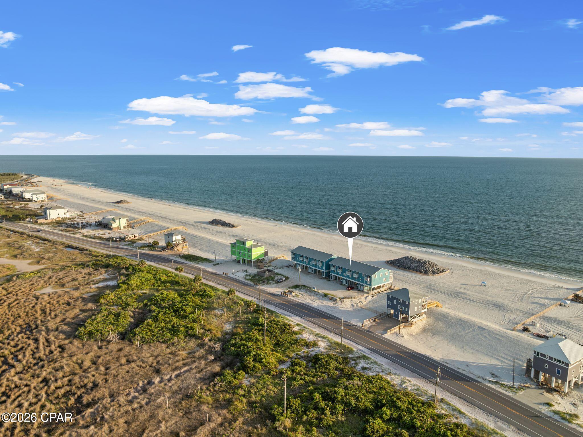 WELCOME TO 3875 CAPE SAN BLAS RD (UNIT B-3), KNOWN AS ''THE HIDDEN PEARL.'' Located in the highly sought-after North Cape area, this 3-bedroom, 2.5-bathroom townhome offers a rare dual-waterfront experience. Here, you are close enough to the water to wake up to breathtaking, vibrant sunrises over St. Joseph Bay and end your evenings watching spectacular, unobstructed sunsets dip into the Gulf of Mexico. Whether you are looking for a private seaside retreat or a lucrative, turn-key addition to your portfolio, this 1,512-square-foot (2,624 sqft total) furnished beach townhome delivers the ultimate coastal lifestyle!

FOR ANYONE WATCHING THE CAPE, THE MONUMENTAL 2026 BEACH RENOURISHMENT PROJECT IS A GAME-CHANGER. Roughly 830,000 cubic yards of fresh, pristine sand has already been successfully placed along the shoreline just north of Stumphole, and crews are staging the rock for the final phase: eight strategically placed, submerged breakwaters. These innovative, nature-based structures are designed to hold the new sand on the beach much longer, absorb wave energy, and drastically slow natural erosion, actively protecting the coastline and cementing the long-term value of your investment on the Forgotten Coast. 

THE LIFESTYLE ON THE CAPE IS UNMATCHED, OFFERING A PERFECT BLEND OF OLD FLORIDA TRANQUILITY AND OUTDOOR ADVENTURE. Spend your late summers snorkeling and scalloping in the shallow waters of the bay, or explore the nearby state parks renowned for their diverse wildlife, sea turtle nesting, and towering dunes. When you are ready to venture out, you are just a short, scenic drive from the historic charm of Port St. Joe, Windmark, and the beautiful coast of Mexico Beach. Spend afternoons strolling under coastal oaks, browsing the boutique shops along Reid Street, and capping off the evening with world-class local seafood at staples like Hunt's Oyster Bar.

SOLD FULLY FURNISHED, THE HOME'S LAYOUT IS PERFECTLY OPTIMIZED FOR ENTERTAINING AND RELAXATION. The spacious, open-concept living area on the main level flows seamlessly onto a large screened-in porch, creating the perfect spot to enjoy the coastal breeze. The fully stocked kitchen boasts fantastic bay views, plenty of prep space, and a convenient breakfast bar, while a large dining table and a half-bath complete this main entertaining floor.

THE TOP FLOOR IS DEDICATED TO REST, FEATURING A MASTER SUITE WITH A KING-SIZE BED, A PRIVATE EN-SUITE BATHROOM, AND ACCESS TO A PRIVATE, OPEN SUNDECK. This vantage point offers some of the most stunning, elevated views of the Gulf that you will ever find, allowing you to drift to sleep listening to the sound of crashing waves. Down the hall, the Bayside bedroom offers a queen bed and its own private balcony overlooking the calm waters of the St. Joe Bay, while the third bedroom features a versatile duo bunk (double bottom, twin top) to easily accommodate guests. These two rooms share a full hallway bathroom, and covered under-house parking provides ample space for your vehicle.

AS A TURN-KEY PROPERTY CURRENTLY THRIVING, ''THE HIDDEN PEARL'' BOASTS A PROVEN, HIGHLY CONSISTENT REVENUE HISTORY. Generating $76,000 in gross rental income in 2022 and $46,275 in 2023, the strong performance continued with $56,226 across 220 booked nights in 2024, and $52,678 over 208 booked nights in 2025. For the 2026 season year-to-date through mid-June, the home has already secured $27,143 across 100 nights. This is as close as you can get to the beach without the beachfront price tag, representing a seamless blend of personal enjoyment and reliable passive income, with all the modern upgrades!