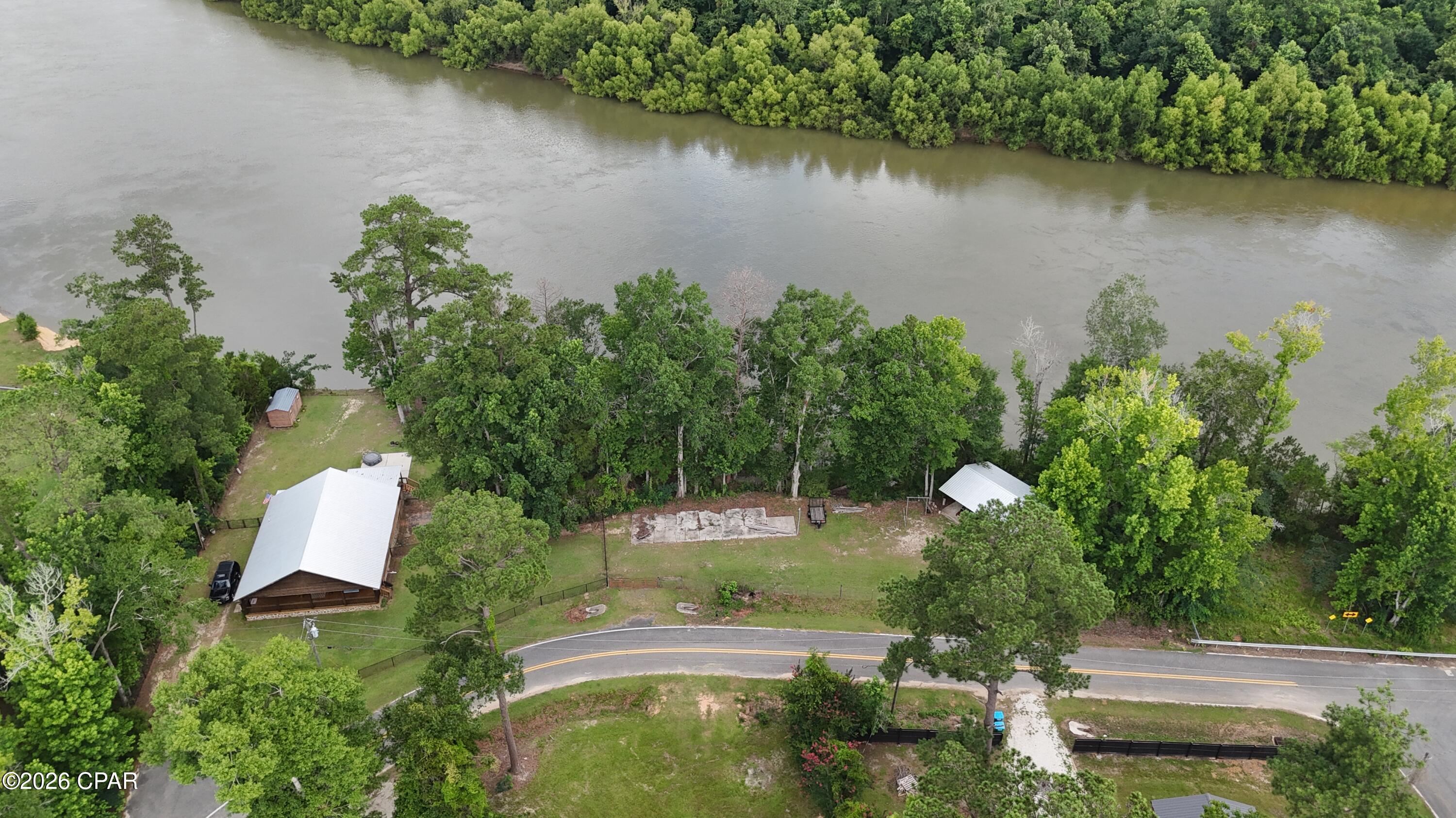 This rare opportunity to own Apalachicola River waterfront property doesn't come along often--and it won't last long. Perched atop a high bluff in the historic Estiffanulga community, this charming three-bedroom, one-bath home offers the perfect blend of relaxation, recreation, and breathtaking natural beauty.

Inside, the open-concept floor plan features vaulted ceilings, abundant natural light, and warm tongue-and-groove pine walls that create a welcoming river-retreat atmosphere. The true centerpiece of the home awaits just beyond the back sliding doors: a covered porch overlooking the Apalachicola River, where unforgettable sunset views provide the perfect backdrop for evening gatherings or peaceful solitude.
Outdoor enthusiasts will appreciate the convenient boat ramp access less than a mile away, as well as close proximity to the Apalachicola National Forest, offering endless opportunities for fishing, hunting, hiking, and exploring Florida's natural treasures.

Additional property features include a 24' x 36' pole barn, fenced grounds, private water well, newer roof, and updated hot water heater. Whether you're seeking a full-time residence, weekend getaway, or investment property, this peaceful riverfront retreat delivers the lifestyle you've been dreaming of.

Come for the spectacular sunsets--stay for a lifetime.