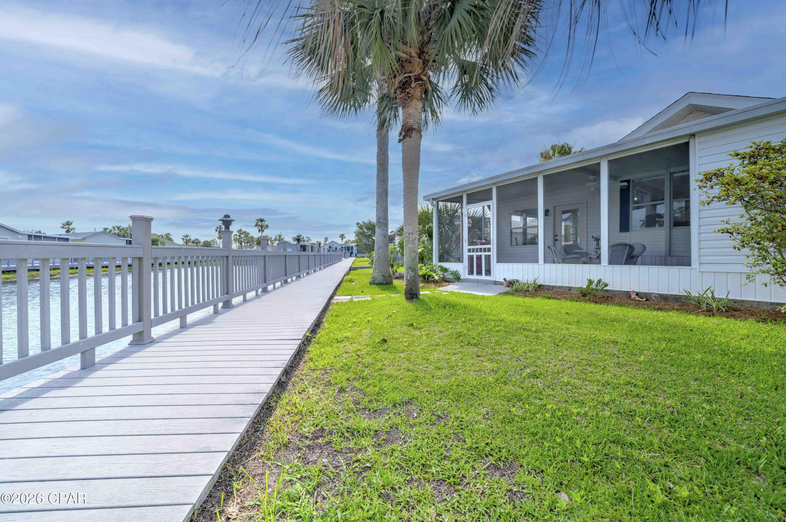 Experience the perfect getaway with stunning waterfront views! Take advantage of this chance to own an updated home in Emerald Pointe Resort, conveniently located near restaurants, shopping, and St. Andrews State Park. This furnished, move-in-ready home offers 1 bedroom and 2 bathrooms. The entryway has been updated for extra seating and storage, leading into a spacious open living area. There's also a second living room that can be partitioned off to accommodate overnight guests. Additional features include an attached storage building, a covered carport, and a large, screened patio overlooking the peaceful community lake. Both living rooms, the screened patio, and the kitchen provide beautiful lake views, making this an ideal beach retreat. Recent updates include a new roof and HVAC system, fresh interior paint, luxury vinyl plank flooring, updated kitchen and bathroom countertops, stainless steel appliances, a new sleeper sofa and sleeper chair, along with other upgraded furnishings.
The home is move in ready, and perfect for a primary, vacation or investment property. The golf cart can be purchased separately if interested. Emerald Pointe Resort is a gated, golf cart friendly community located in the heart of Panama City Beach close to restaurants, shopping, and the world's most beautiful beaches. Amenities include a large clubhouse, exercise room, 2 pools (one heated seasonally), hot tub, lake with boardwalk, and shuffleboard court. HOA fee includes water, sewer, garbage, Wifi, and lawn service. All information is approximate and should be verified by buyer if important.