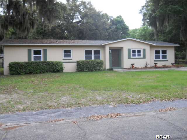 This lovely Cove home is nestled among the century oaks and located on a quiet and peaceful road. The home has been updated and ready to occupy. All hardwood floors have been refinished, the kitchen is in a new location, stainless steel appliances with great space plus a cozy eating area. All new windows throughout, an updated bath plus all new paint throughout. The over sized backyard is fully fenced with alley access to bring in boats or other toys. This is the perfect starter home with no maintaninence required.