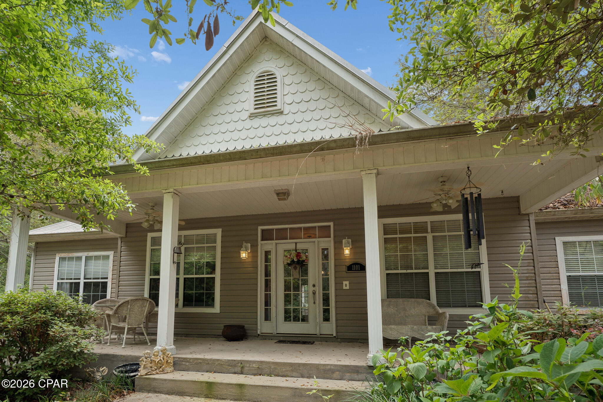 **CURRENTLY UNDER CONTRACT, SELLER WILL CONSIDER BACKUP OFFERS   Welcome to your private retreat just 15 minutes from Lynn Haven. This spacious 4-bedroom, 2.5-bath home sits on 5 acres, offering plenty of room to spread out and enjoy peaceful surroundings. A low-maintenance metal roof adds durability, while the interior features high ceilings and a thoughtfully designed layout.

The spacious primary suite offers two walk-in closets for ample storage. The second bedroom near the entry includes sound barrier insulation--ideal for a home office or quiet space. The oversized, insulated garage offers an additional heated and cooled space, perfect for a workshop, craft room, or flex area. Inside, you'll find solid wood kitchen cabinetry, a large pantry, and a cozy wood-burning fireplace.

Additional features include plywood-backed exterior siding under the Vinyl siding for added strength,  as well as lightning surge protection.  Priced to sell, this property is ready for your personal touch. If measurements are important, please verify.