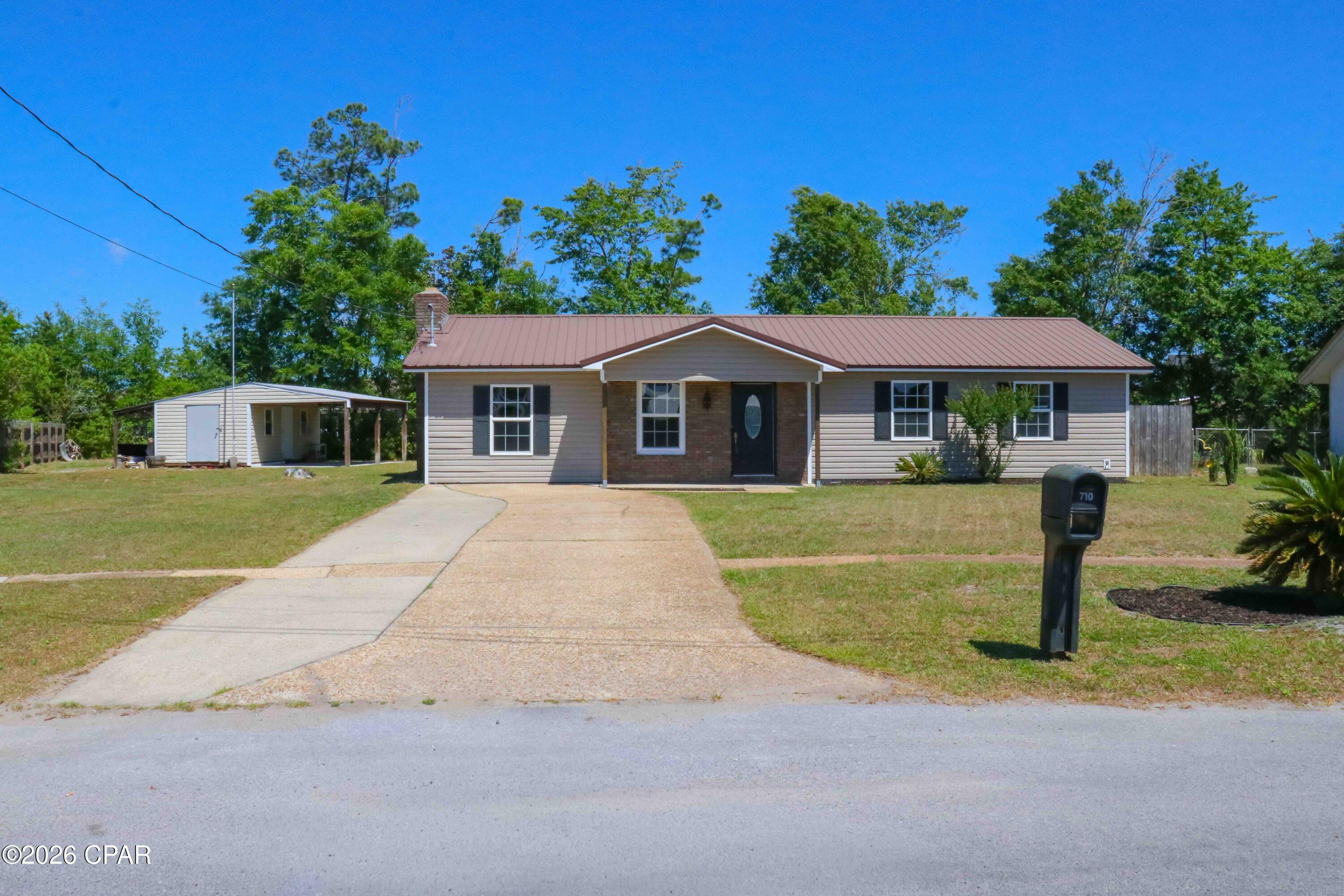 Move-in ready and packed with features, this Lynn Haven home checks all the boxes with NO HOA, an oversized lot, golf cart access, a 312 sq ft Florida Room, and a powered 16×12 workshop with attached carport. There is also room for boats, RVs, trailers, and all your recreational toys--a combination that is becoming increasingly hard to find. Seller is offering a $1,200 refrigerator credit with an acceptable offer.

Welcome to 710 E Pine Forest Drive, a refreshed 3-bedroom, 2-bath home offering flexible living space on a peaceful corner lot with minimal through traffic. Fresh interior paint and recent updates give the home a bright, clean, move-in-ready feel. The enclosed Florida Room, surrounded by insulated double-pane windows, provides a versatile space ideal for a second living area, home office, playroom, or relaxing retreat overlooking the backyard.

The oversized lot offers exceptional freedom with no HOA restrictions and ample side yard space to comfortably accommodate boats, RVs, or additional equipment. The property also features a powered 16×12 workshop with electricity and a covered parking area, perfect for projects, hobbies, storage, or business use.

Beyond the property, the Lynn Haven lifestyle truly stands out. This golf cart-friendly area provides convenient access to local restaurants, grocery stores, parks, and everyday amenities. Residents enjoy nearby access to North Bay and Deer Point Lake boat ramps, along with parks such as Sharon Sheffield Park and Cain Griffin Park, featuring sports fields, playgrounds, dog parks, and walking trails. Local favorites include fishing at Bailey Bridge, golf at Panama Country Club, and regular community events including concerts, holiday parades, and fireworks.

You are also just 20-25 minutes from the white sandy beaches of the Gulf and the dining, shopping, and entertainment of Panama City Beach.

Homes in Lynn Haven with oversized lots, no HOA, and room for recreational storage continue to stand out in today's market. Schedule your private showing or virtual tour today.

All information deemed reliable but not guaranteed. Buyer to verify if important. Video walkthrough and 360° tour available. Far Rear shed does not convey and has been removed.