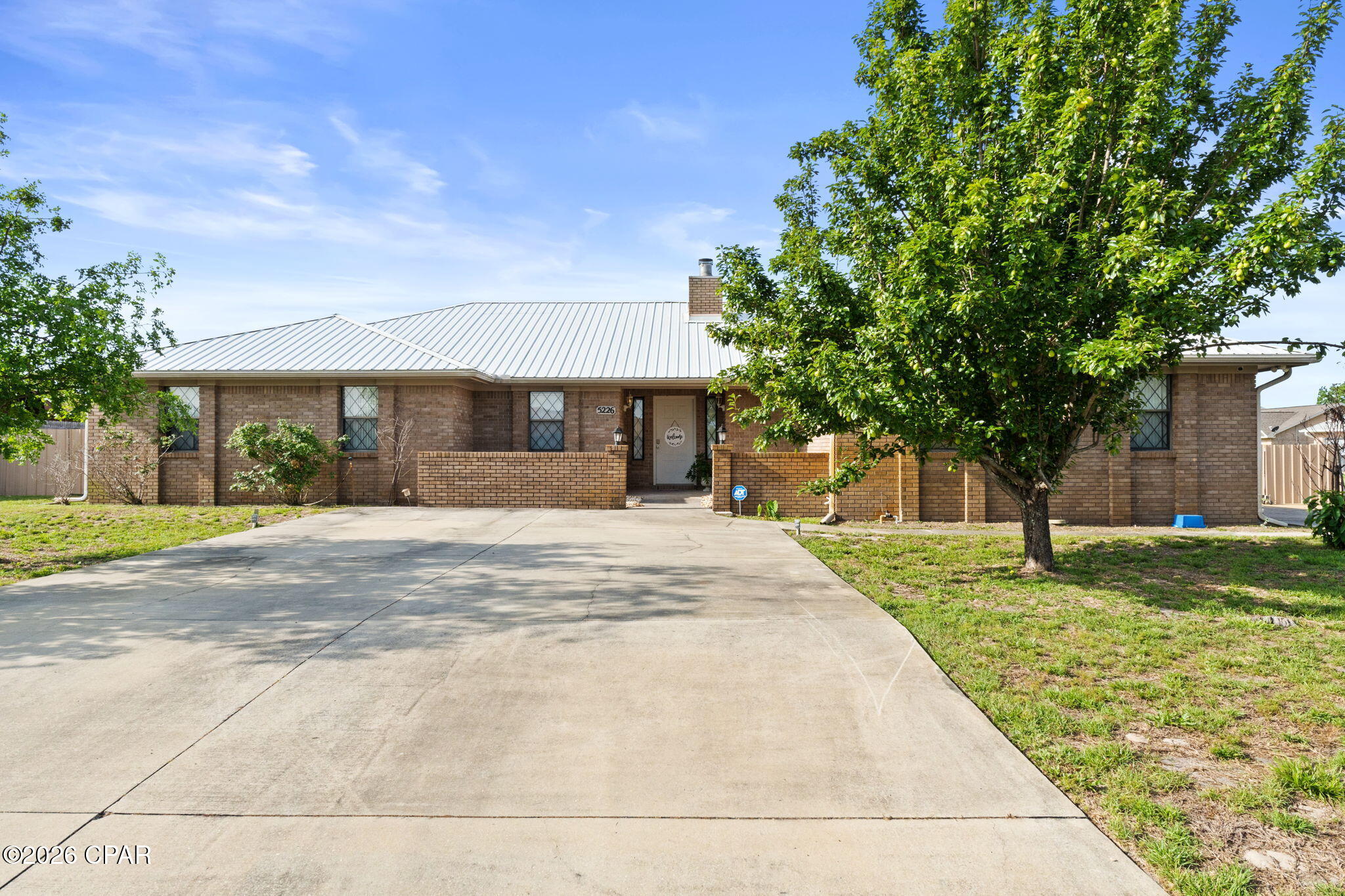 A beautiful all brick home on a spacious corner lot. Located in the desirable Springlake subdivision. A sparkling inground pool, summertime is upon us! Enter into a nice floorplan that offers plenty of space. Sunken living room with brick fireplace. A stunning kitchen featuring custom cabinetry, granite countertops and stainless-steel appliances. A 24x9 sunroom next to the living space. Master suite is very spacious with huge walk-in closet. Master bath features double vanities, separate tub and shower.  3 guest rooms with closets plus a bonus room with a barn door that could also be an office or an additional bedroom to make it a 5 bedroom. From the sunroom, double French doors lead to the screened in porch overlooking the pool. This backyard is an oasis and perfect for entertaining family and friends. There is a large, all brick detached garage with a side door to a plumbed bathroom for swimmers, just needs new pieces installed. Detached garage has been finished out to be a mother-in-law home with an additional full bathroom. It has electric panel and wiring is complete, can lighting ready and has already had some permitting, just needs to be finished to your preference. Fully fenced back yard. Pool is also heated, just add a new propane tank. Main home has 4 bedrooms and 2.5 baths. Brick shop has 1.5 bathrooms. Main home also has a 2-car garage and driveways on both sides of the corner lot, perfect for the large family with more than two vehicles, or boat and rv parking. Metal roof in Dec 2018. No flood zone and no Hoa. Underground city utilities. Excellent proximity to Tyndall AFB and Mexico Beach. Close to restaurants and shopping. Pride of ownership shows with this one. Schedule your visit today!