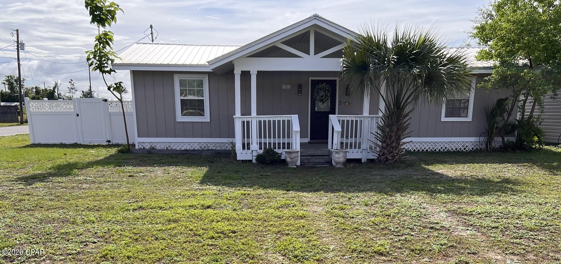This is a cute older Lynn Haven home that has been upgraded and remodeled over the years.  This is an all electric home with utility bills around $130/month.  Very energy efficient.  The ac ducts and system was cleaned approx. 3 yrs ago and a new thermostat installed.  There is crown molding  in the living room and several other areas.  It has a nice large covered front porch and a smaller covered back porch, and a large fenced back yard.  This is an affordable home with many positive features.  New paint inside and out, tile backsplash in the kitchen, laundry room with washer and dryer.  The third bedroom does not have a built in closet but does have a wardrobe for clothes.  It has a 4 year old metal roof and vinyl fenced back yard.  No flood zone, No HOA fees, nice corner lot.  The house is being offered with limited furnishings, and a new dishwasher.