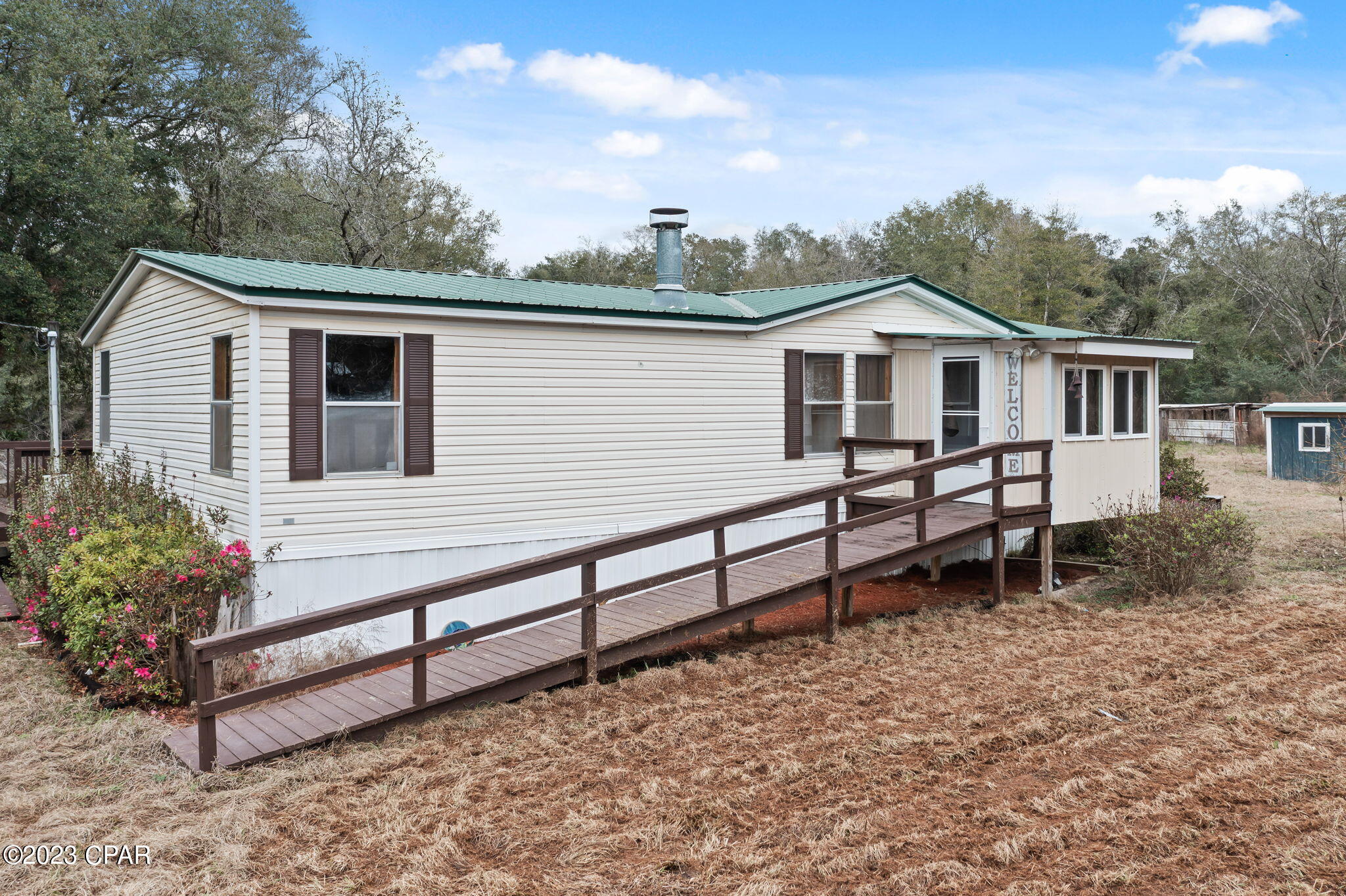 CURRENTLY UNDER CONTRACT, SELLER WILL CONSIDER BACKUP OFFERS - NEED A PLACE THAT CHECKS THE BOXES?  This one will probably check most of the boxes and more.  It is located in the country on over a 3.5 acre corner lot with partial fencing already in place.  There are multiple outbuildings, detached parking areas for recreational vehicles, front and back ramps for accessibility, an enclosed front sitting area, a covered back porch overlooking the pond and... it has a separate private entrance on the back side of the property.  The interior has a spacious open concept, a woodburning fireplace, walk-in closets in every bedroom and a garden tub with a separate shower in the master bathroom.   Contact your favorite realtor today to schedule a showing!