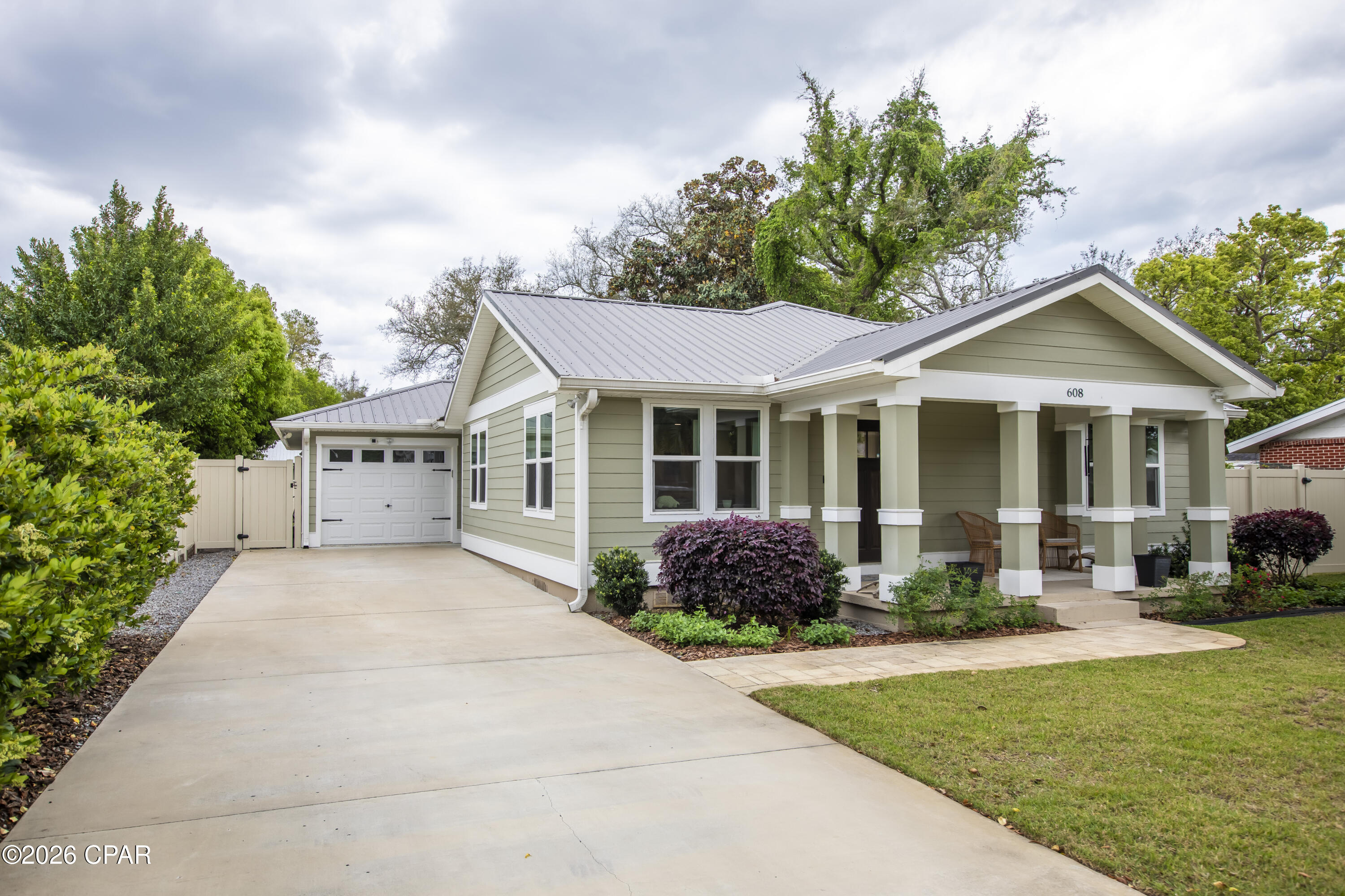 'CURRENTLY UNDER CONTRACT, SELLER WILL CONSIDER BACKUP OFFERS' Beautifully renovated Craftsman-style home blending timeless charm with modern upgrades. Originally built in 1945, this home was taken down to the studs in 2022 and thoughtfully expanded to nearly double its original size, while preserving character with original trusses and architectural elements.This 3-bedroom, 2-bath home features an open-concept layout with luxury vinyl plank flooring throughout and a spacious living area perfect for everyday living and entertaining. The chef's kitchen is a standout showcasing quartz countertops, a large center island, stainless steel Signature Series appliances, gas range and decorative hood, farm sink, and abundant cabinetry and with custom pull-out drawers for optimal organization. A picture window above the sink overlooks the private backyard, and a cozy breakfast nook offers the perfect space for gatherings. The primary suite offers ample space, a large walk-in closet with built-in shelving and drawers, and a beautifully designed ensuite bath with double vanity and an oversized, floor-to-ceiling tiled shower. Two additional bedrooms are generously sized and share a full guest bath. Exterior features include two concrete driveways (front and rear) with plenty of room for vehicles, boat, or RV, plus alley access for added convenience.The fully fenced backyard is designed for relaxation and entertaining, featuring a spacious deck, gas fire pit with paver surround, and a lighted pergola ideal for outdoor dining. Additional highlights include a Generac whole-home backup generator, a heated and cooled bonus room perfect for a home office or hobby space, and a private well-fed irrigation system. The meticulously maintained yard showcases mature landscaping, including knockout roses, lush shrubbery, and a beautiful oak tree providing shade and curb appeal. Located in The Cove, a golf cart community within walking distance to restaurants, schools, coffee shops, the Yacht club, and a boat ramp-this home truly offers the best lifestyle and location. Don't miss this one, schedule a showing today! It's a WOW property!