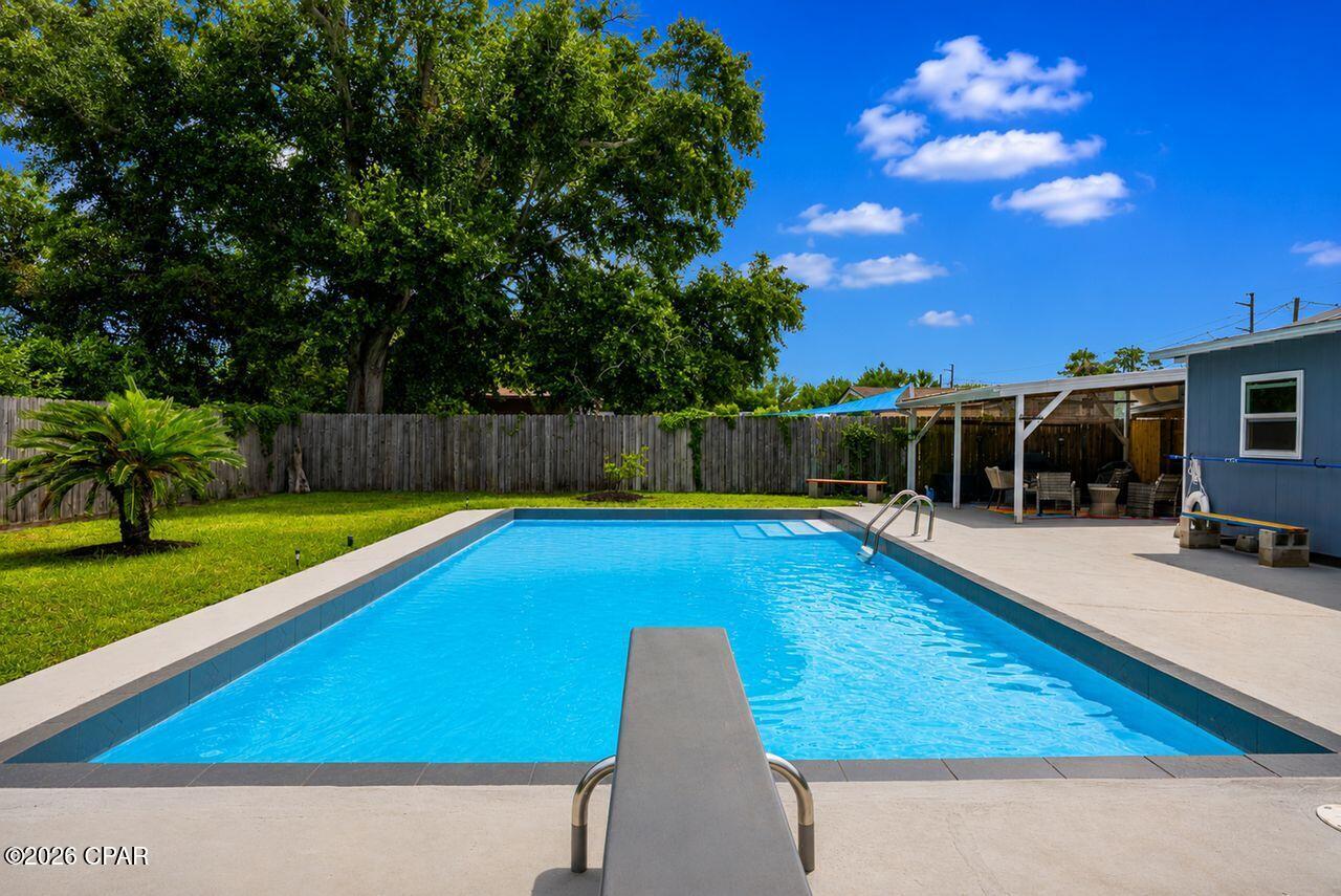 Enjoy this Cozy Cottage Charm located near 23rd Street, Gulf Coast College, FSU, beaches, restaurants and shopping. This cute home was updated and remodeled several years ago.  It includes a large back yard with a fabulous in-ground pool.    The home features 3 bedrooms and fully remodeled main bathroom and kitchen.  The kitchen has abundance of cabinetry all in white, granite counter tops and like new stainless-steel appliances. New metal roof installed in 2024. Enjoy the cozy back patio fully fenced in, with the kids swimming in the pool.  Furnishings negotiable.