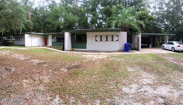 PRIVATE 3,000+ SQ FT HOME ON 1.86 ACRES - FULLY FENCED WITH INGROUND POOL!! The interior features 2 XL living rooms (both with fireplaces), 3 large bedrooms, 3 full bathrooms, 1 bonus room, a spacious dining area, an open kitchen, an interior laundry room, numerous storage closets, built-in shelving, skylights and big windows for ample natural light. The kitchen features a breakfast bar, a huge pantry and a built-in china cabinet. Bedroom 1 has a bonus area perfect for office space or a sitting area. The 2nd bedroom is set up with a partition to make two 12x10 rooms (if desired). The 3rd bedroom is split from the other two and has its own interior bathroom. The bonus room could be used for whatever you need (bedroom, office, play room or home business). The exterior features an attached 18x9 workshop, a 23x23 carport, a 41x14 screened-in porch with fireplace, a screen enclosed pool and a detached storage building. The entire 1.86 acreage parcel is fenced with a chain link fence. The back part is located on Gainer Bayou; however, there is no access to the bay. The water would accommodate a canoe or small fishing boat. This home has so much to offer; call today for your private preview. All ages, sizes and measurements approximate; buyer to verify if important.