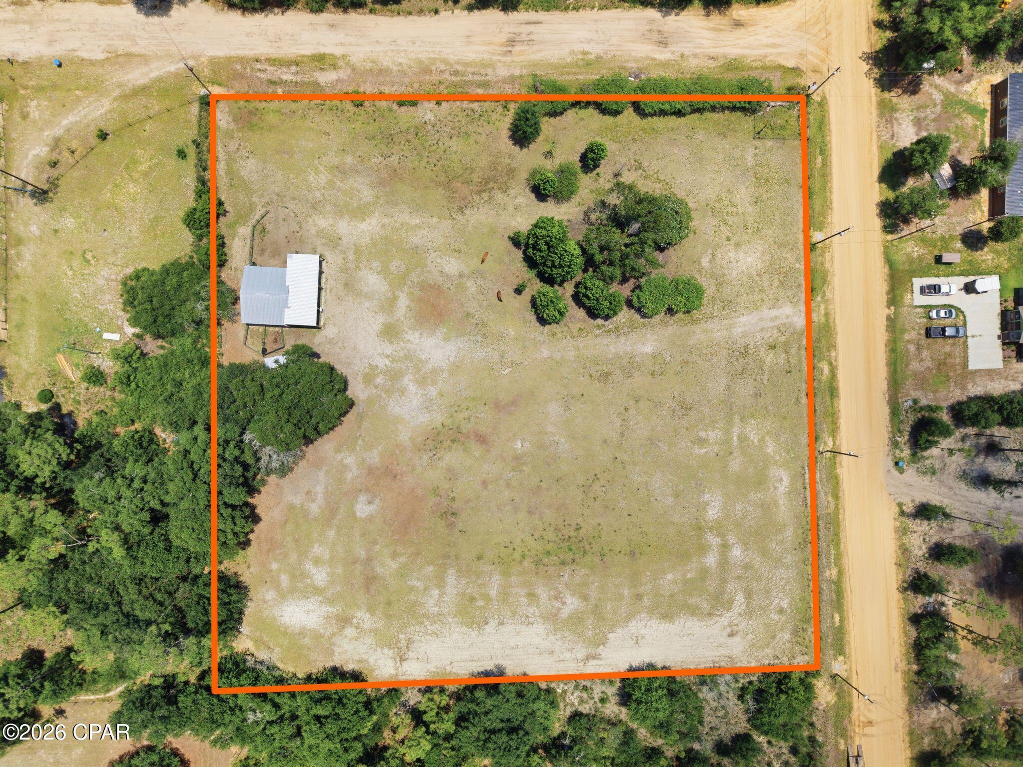 Escape to the peace and privacy of country living with this beautiful 2.5-acre parcel, perfectly located just 1/4 mile from Highway 231. Whether you're looking to build your dream home, start a small homestead, or enjoy a weekend retreat, this property is ideal.

A new barn is already in place for your livestock or equipment. The lot is level and cleared. In addition, there is a covered RV parking spot.

Best of all, you're less than 45 minutes from the Gulf's stunning white-sand beaches, giving you the opportunity to enjoy coastal living without sacrificing the tranquility of the countryside.