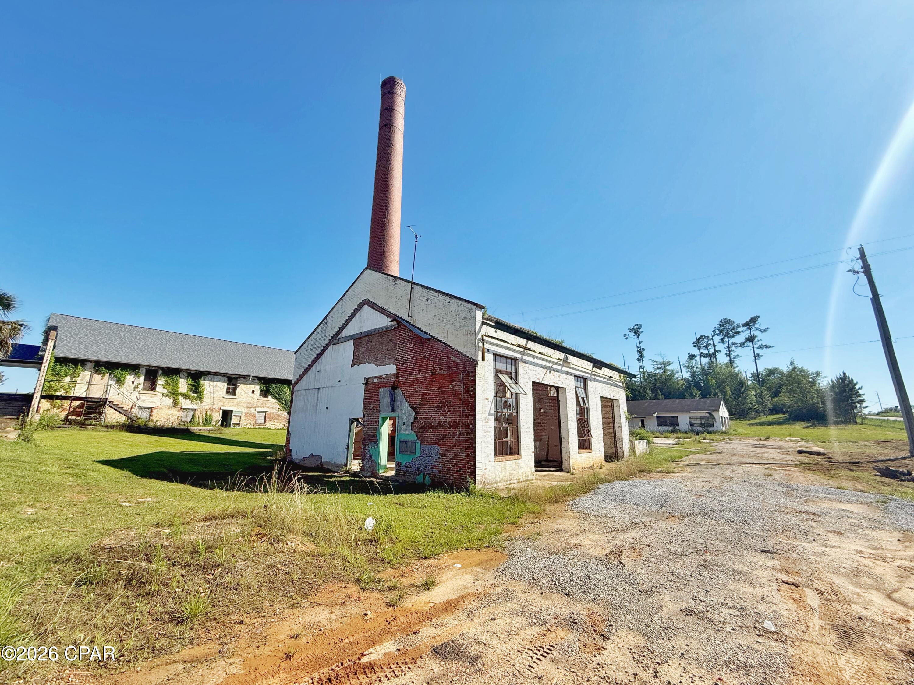 Positioned within the newly formed Endeavor Park, this historic Smokestack building offers a rare opportunity for visionaries, investors, and entrepreneurs to become part of the revitalization of one of Marianna's most transformational redevelopment areas. Situated inside the expansive 1,200-acre park, this property is ready for renovation, restoration, and imagination to bring new life back into a once-prominent structure.
Surrounded by momentum and progress, the area is already seeing significant investment and redevelopment with neighboring projects including the newly opened Jackson County Civic Center directly across the street, as well as the growing campuses of Chrome Ministries and Next Steps. The vision for Endeavor Park centers around renewing and repurposing a historic area of Jackson County into a thriving destination for business, community, and opportunity.
Bring your business concept, creative vision, or redevelopment plans and help shape the future of Jackson County by revitalizing the original Smokestack building into something remarkable once again. Commercial zoning and city utilities available for hookup.