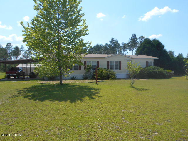 FARM FOR SALE!! Rare to find a really nice mini farm like this one. The land is beautiful, and this home is well built with a nicely done attached double carport. As you enter the home there is a large laundry room. The kitchen has a really nice island looking out to the row of windows that add lots of light. There is a fireplace in the great room that exits the wonderful huge covered back porch. There are two bedrooms and one bath on the back side of the home and the large master bedroom and bath compose the other end of the home which is nice and private. The fences are there with wonderful pole barn, so bring the horses. The land is all cleared and high and dry. Walk over it and enjoy seeing the deer tracks on the back of the property. The present owner has done all the work preparing the farm; there is also a nice storage or work building in the back. This is no ordinary home, it is well cared for, and a rare find. Call quick for appointment to see! Beware of dog, do not approach without a realtor appointment. All room sizes estimated, approximately five acres+-, please verify all information.