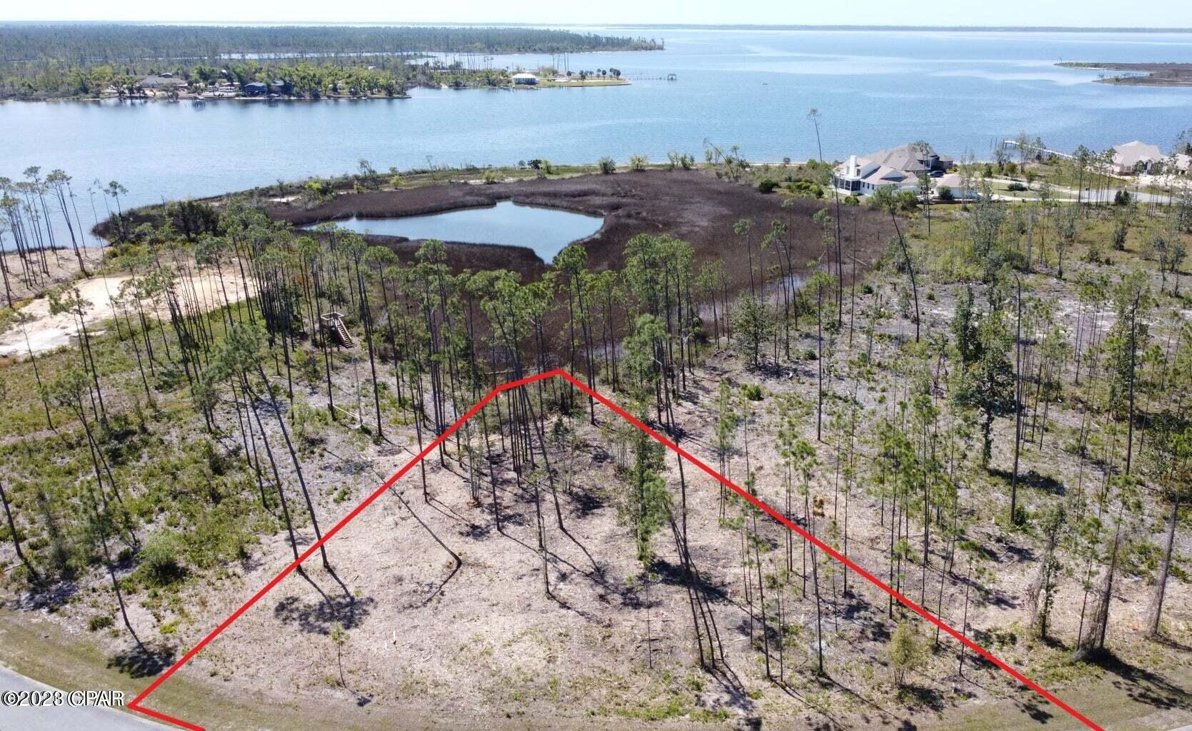 Stunning Waterfront Home site in the Desirable Laird Bayou! A perfect place to build your Dream Home. Experience open views over East Bay and Cook Bayou! At over half an acre, you have plenty of space for all home styles. This home site is very unique as it features 243 ft on the street, making circle driveways and 3 car garages possible. Laird Bayou is a gated waterfront community that offers amenities such as pool/with bathhouse, private boat launch and day dock which gives every home site Bay and Gulf access. It also has an Rv/Boat storage area. Beautiful custom Homes throughout. Explore the beautiful waters of East Bay which is home to some of the best flats fishing in North Florida. Great Proximity to Mexico Beach and TAFB. Call for a private tour of this community.