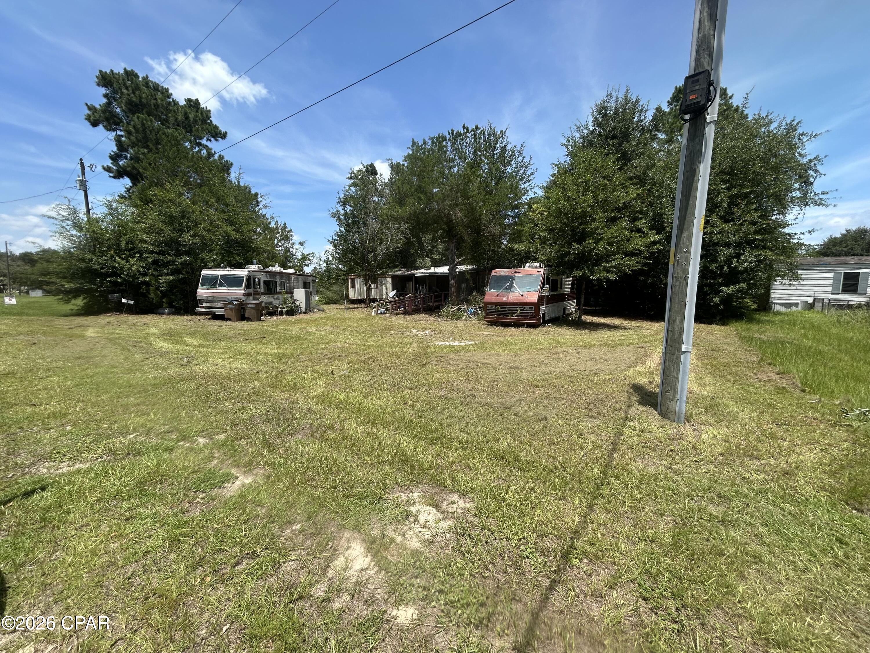 Opportunity Awaits on This .50-Acre Homesite Near Howard Creek Landing

Tucked away in a quaint and peaceful neighborhood, this .50-acre property offers a wonderful opportunity to own a mostly wooded homesite with plenty of natural charm and privacy. Mature trees surround much of the property, creating a serene setting.

One of the property's most attractive features is its prime location. Situated just 4 minutes from Howard Creek Landing, you'll enjoy quick access to boating, fishing, kayaking, and the beautiful waterways that make this area such a sought-after destination. Despite its close proximity to the water, the seller reports that the property has never flooded, offering added peace of mind while still allowing you to enjoy all the benefits of nearby waterfront recreation. Whether you're looking for a permanent residence, weekend getaway, or investment opportunity, you'll appreciate being so close to outdoor recreation while still enjoying a quiet neighborhood atmosphere.

The property currently includes a 1984 home that is being sold as-is. While the home's condition is unknown and it will likely require repairs or renovation, it presents an opportunity for those with vision to restore the existing structure or start fresh with a new build. Two RVs are also located on the property and are currently in the process of being removed by the seller.

Adding to the property's potential are existing utility improvements, including a well, septic system, and power service already on site. The condition and functionality of these improvements are unknown and should be independently verified by the buyer. However, having these utilities already in place may offer future value and convenience for redevelopment plans.

Whether you're searching for an affordable homesite, a weekend retreat near the water, or a property with room to create your own vision, this wooded parcel offers endless possibilities. With its peaceful setting, established utilities, and close proximity to Howard Creek Landing, this property is ready for its next chapter.