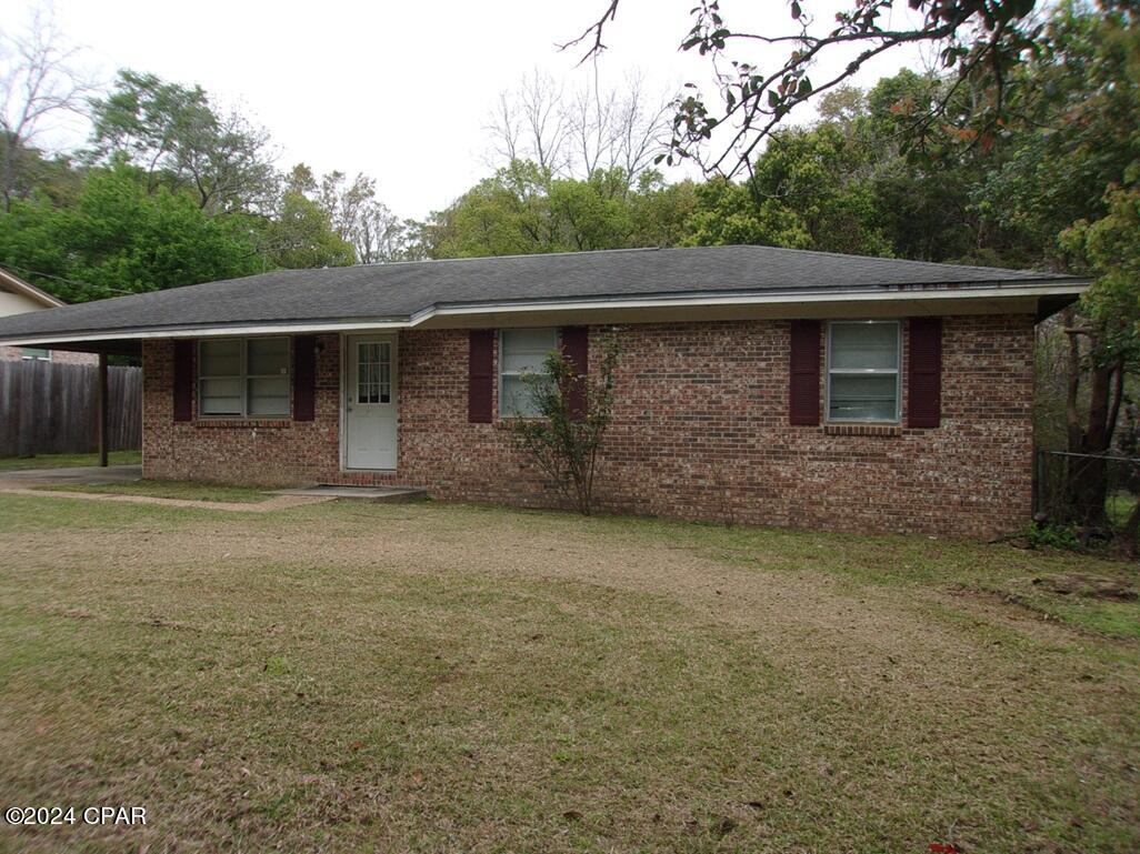 Cozy 3-bedroom 1 bath brick home on about half an acre lot. Outskirts of town. Has good sized living room, kitchen and dining room.  Ceramic tile in the kitchen, dining room and bath. Attached carport.  Covered porch on the back.  New electric panel box. Nice and quiet neighborhood. Walking distance to town.  Check it out.