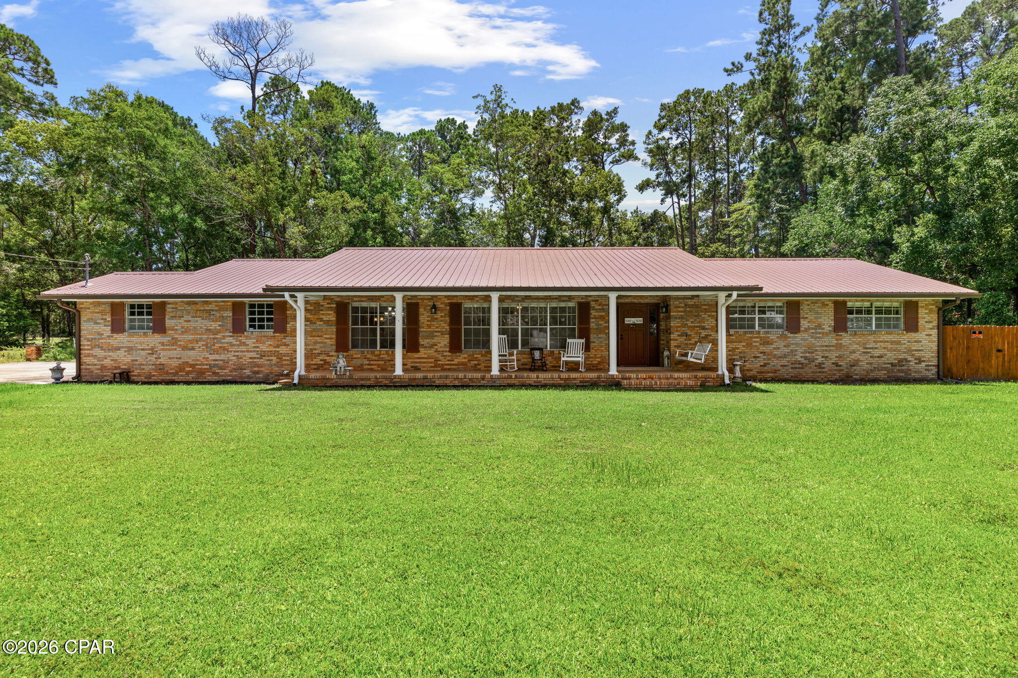 Welcome home to this well-maintained 4-bedroom, 2-bath brick home situated on a generous 0.48-acre lot in the heart of Bonifay. Offering the perfect combination of comfort, functionality, and outdoor living, this property is ideal for growing families, those working from home, or anyone looking for extra space to spread out.

Step onto the inviting covered front porch and through the front door into a spacious entryway that creates a warm first impression. Just to the left, you'll find a versatile den, perfect for a second living area, home office, playroom, or media room. Continue into the expansive main living room, where a cozy wood-burning fireplace serves as the centerpiece for gathering with family and friends. another great feature you will notice throughout the home is the oversized doorways, these are wide enough for a wheelchair making this home. 

The thoughtfully designed kitchen offers dark custom wood cabinetry, stainless steel appliances, a convenient breakfast bar, and a designated pantry, making meal preparation both functional and enjoyable. Whether you're hosting holidays or casual dinners, you'll appreciate having both a formal dining room and a separate breakfast nook, giving you flexible spaces for entertaining and everyday living.

The oversized primary suite provides a relaxing retreat with his-and-her closets and a private ensuite bathroom. Three additional spacious bedrooms offer flexibility for children's rooms, guest accommodations, a home office, workout space, or hobby room to fit your lifestyle.

Additional features include a dedicated laundry room with a utility sink, a 1-car garage, and numerous recent updates for peace of mind, including a roof that's only one year old, a two-year-old HVAC system, and new gutters.

Outside, you'll find a large covered back porch overlooking a spacious privacy-fenced backyard, providing plenty of room for entertaining, pets, gardening, or simply enjoying your own private outdoor oasis.

Conveniently located in the heart of Bonifay, you'll enjoy small-town charm while remaining just 47 miles from the sugar-white sands and emerald waters of Panama City Beach, making weekend getaways an easy drive.

If you've been searching for a move-in-ready home with generous living space, modern updates, and a fantastic location, this home is ready to welcome you.