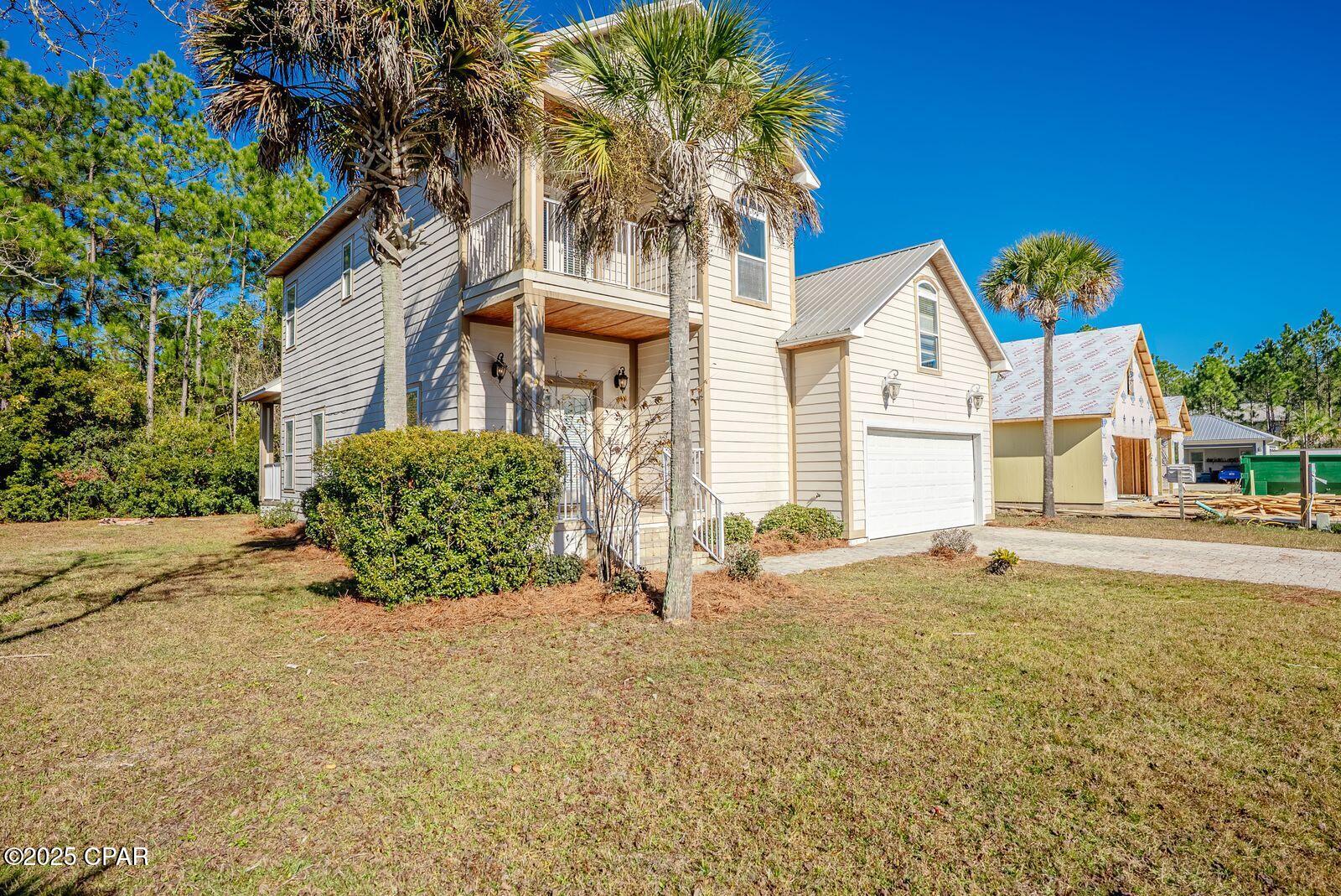 Location! Location!    This home is located only minutes from San Destin, white sandy beaches, and 30A.  From the West end of Panama City Beach, you are only 20 minutes away and 30 minutes from the International Airport. This Beautiful 4 BR 2.5 BA sits  on a spacious lot with no HOA. It is a small Subdivision with a Cul De Sac.    Enter the French doors to the family room with fireplace & into the dining area which is  open to the kitchen, thus seating 4 at the breakfast bar.  Custom crown molding throughout the home and tiled flooring through out except for 2 bedrooms. There is a large pantry & custom cabinets, stainless steel appliances, granite counter tops, and additional storage. This great open floor plan flow circles you back into the family room, half-bath, master bedroom on the first floor, and  laundry room..The 1st floor primary bedroom has custom walk-in closet, en suite bath, separate shower & Jacuzzi tub,  10Ft ceilings make this home feel open and expansive.  Upstairs offers 2 oversized bedrooms, 1 with attached balcony. Additional bedroom could be an office, den or game room. Main level attached garage with shelving located next to the  large walk in laundry room with sink. This home has just received fresh interior paint. Land is Conservation Residential.  New Air conditioner system installed in 2024. The lot goes further back if you wish to clear more of the land.  This area is booming with new restaurants, shopping etc.