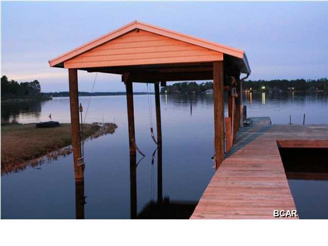 Bring the boat and your fishing poles! Gorgeous Deerpoint Lake home with endless views of Deerpoint Lake. This well manicured, large lot has a fenced backyard, firepit and a boat dock with a covered lift. There is a nice open deck and an enclosed screen room of the Master bedroom. The kitchen has an island with butcher block, perfect for gathering the family around. There is a breakfast area in the kitchen and a formal dining area. The Master, Living and Guest bedrooms all have views of the lake. One of the bedrooms is EXTREMELY large and has room to be converted to a 4th bedroom. Home has had recent upgrades such as a newer hot water heater, roof in 2003, extra insulation blown in the attic and energy efficient windows. There is a sprinkler system that draws off the lake. The location