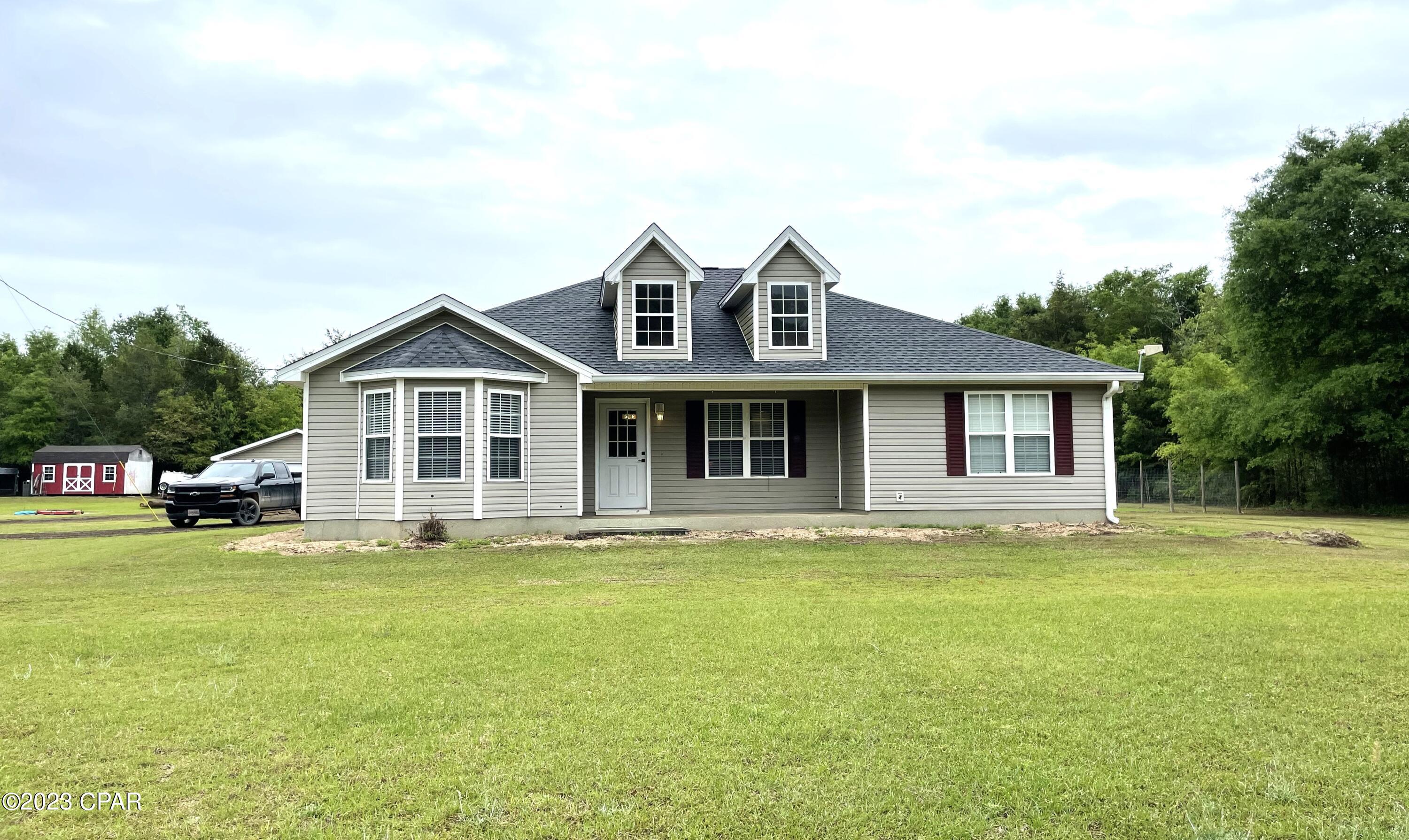 This is country living at its finest! You don't want to miss this newly roofed 2079 sq. ft. home on over 18 acres in rural Bonifay! This sprawling property features a private drive, a large yard surrounded by mature trees, and a 36x24 ft shed/workshop. The workshop has a double car garage door on one side and a single on the other. Upon entering the home you're greeted by a large open living room and kitchen area. The kitchen features stainless steel appliances, white cabinetry and beautiful wood backsplash. A 2nd large living area can be found off the back of the kitchen. This split floor plan home has a oversized master bedroom with bathroom and walk in closet on one side and 2 bedrooms and full bath on the other. The large covered back porch is perfect for entertaining!