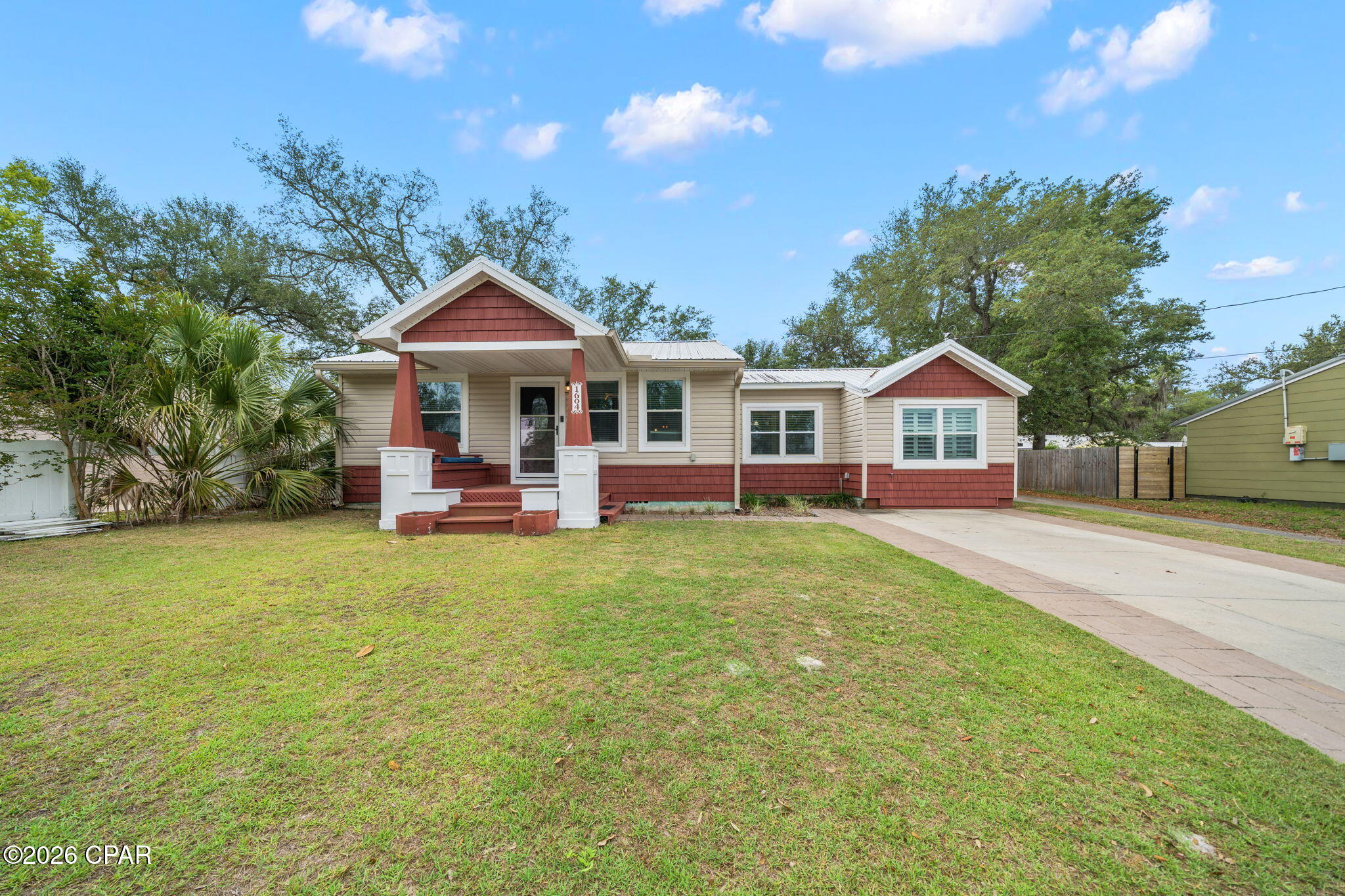 Under Contract with 72-Hour Kick-Out Clause. Across from the Bay in the historic Cove neighborhood sits a home exuding charm and character offering 3 bedrooms, 2.5 baths, a detached home office with an adorable front porch! This Cove cottage features almost 1800 square feet of living space with a large open deck on the back, overlooking the shaded back yard, perfect for entertaining. 

You're greeted with a cozy, covered front porch and enter into a stunning great room with custom millwork throughout including a stunning coffered ceiling flowing throughout the living room, kitchen and dining area. The living room is flooded with natural light, spacious and includes a separate area great for kids to play or would function as a great conversation area. The kitchen is outfitted with beautiful granite countertops, stainless steel appliances and a gas cooktop with accent lighting above the cabinetry. The dining room overlooks the backyard with lush oak trees. 

Just off the kitchen is a guest bedroom with en suite bath complete with a tub/shower combo. An additional guest bedroom is found toward the back of the home off the dining room. A great feature of this home that is rare in Cove homes is a half bath which is in an excellent location for guests - just off the living room area. The hallway with the powder room leads to the primary suite which is a true retreat! 

The primary suite includes double closets, vaulted ceilings, natural light and a en suite bath to include a dual shower head, oversized tiled shower, double vanities and water closet. This home is a true split floor plan! 

One of the best features of this home is the building in the backyard. This 2023-built permitted outbuilding has a home office complete with plumbing and electrical and a half bath. This is an incredibly desirable feature for those who wish to work at home but be separated from the home for work. The outbuilding also has a work shop area great for hobbies and outdoor work. This building is also insulated for temperature control and encapsulated to keep it free from pests. The right side of the home also gives access to a city-maintained alley that runs along the back yard fence and gives easy access for trailers, boats, etc. 

1604 Tyndall Drive offers a 2020 roof, 2019 windows, 2020 HVAC, tankless water heater, whole house surge protector, Aquasauna water filtration system (complete with 6 months of filters!) and 2017 Maytag appliances. The Cove is a charming golf cart-friendly community with NO HOA and highly sought after for it's water views as well as its city-maintained playgrounds and parks. 

Just 2 homes down from this home you'll also enjoy a baseball field and new playground area for kids and families. Enjoy events in the community throughout the year! This neighborhood is adjacent to the fast-growing downtown Panama City area which features restaurants, a marina, shopping, breweries, farmers markets and events year-round. The St. Andrews Bay Yacht Club is an incredible offering as an addition amenity in the neighborhood and just a few minutes away. Ideal for boaters, fisherman and those who love to enjoy events, as a member, you will enjoy access to a private boat launch, dining waterfront and activities weekly. 1604 Tyndall Drive in the heart of the Cove is waiting for you!