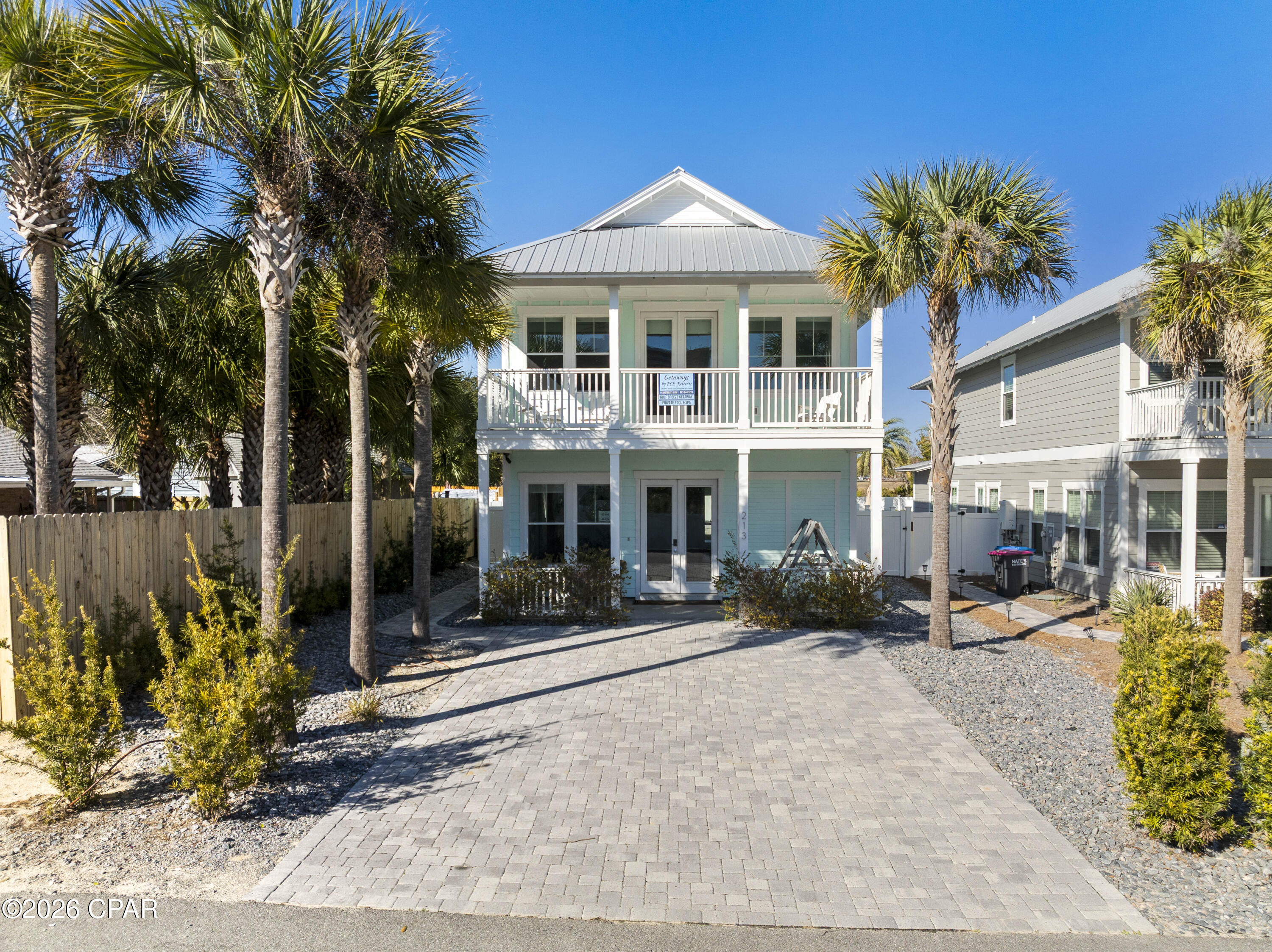 Designed for effortless coastal living & outdoor enjoyment, this exceptional custom beach home offers a private retreat just moments from the sugar-white sands of Laguna Beach, close enough that a golf cart is simply unnecessary as a 5-minute walk will have your toes in the sand. Thoughtfully crafted & built to high standards, the home blends durability, comfort, and a relaxed beach lifestyle ideal for both personal use & investment potential. The outdoor living space is a true highlight, featuring a private pool with spillover spa, outdoor shower, Fun Kick pool table, sandbox, cornhole, 4Score, and generous space for entertaining & recreation. A paver driveway provides ample parking, while the fenced backyard creates a secluded setting designed for year-round enjoyment. Inside, the home offers 4 well-appointed bedrooms, including a primary suite on both levels, and 3.5 bathrooms, providing privacy & flexibility for guests. Shaded porches on both levels extend the living space outdoors, offering quiet retreats for relaxation.

The interior is designed with entertaining in mind, anchored by a spacious kitchen featuring 42-inch cabinetry, quartz countertops, a gas slide-in range & cooktop, a center island with breakfast bar, and a walk-in pantry. Two sets of 8ft French doors create a seamless indoor-outdoor flow, while a metal roof, high-impact windows, tankless water heater, and dedicated laundry room add to the home's quality construction & long-term value.

Perfectly positioned near Pier Park's shopping & dining, and offering an abundance of on-site amenities, this inviting beach retreat delivers a fun, family-friendly lifestyle with strong appeal as a primary residence, vacation home, or income-producing property.