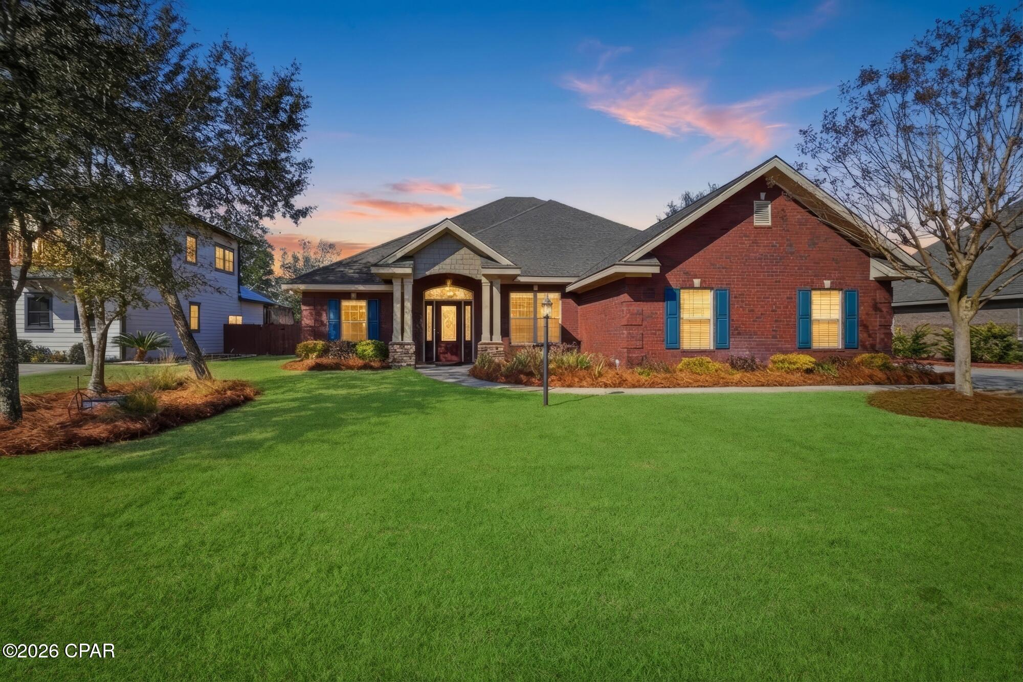 Custom-built  home, featured in the 2015 Panama City Parade of Homes, located in the gated community of Lake Merial. This home has been meticulously maintained and still shows like new.

Loaded with upgrades including spray foam attic insulation, tray ceilings in the master, great room, and dining room, and handscraped engineered wood flooring throughout the main living areas and primary suite. The kitchen features a custom glass tile backsplash.

The spa-like primary suite offers his-and-hers closets, double vanities, a soaking tub, and an oversized custom walk-in shower. All bathrooms feature upgraded decorative tile. Additional highlights include a shallow well for the sprinkler system.

Conveniently located near Panama City Beach, Tyndall AFB, and the Naval Support Activity, while enjoying the peace of Lake Merial's 300-acre spring-fed lake community in north Bay County.

Don't miss this beautiful custom homeâ”schedule your showing today.