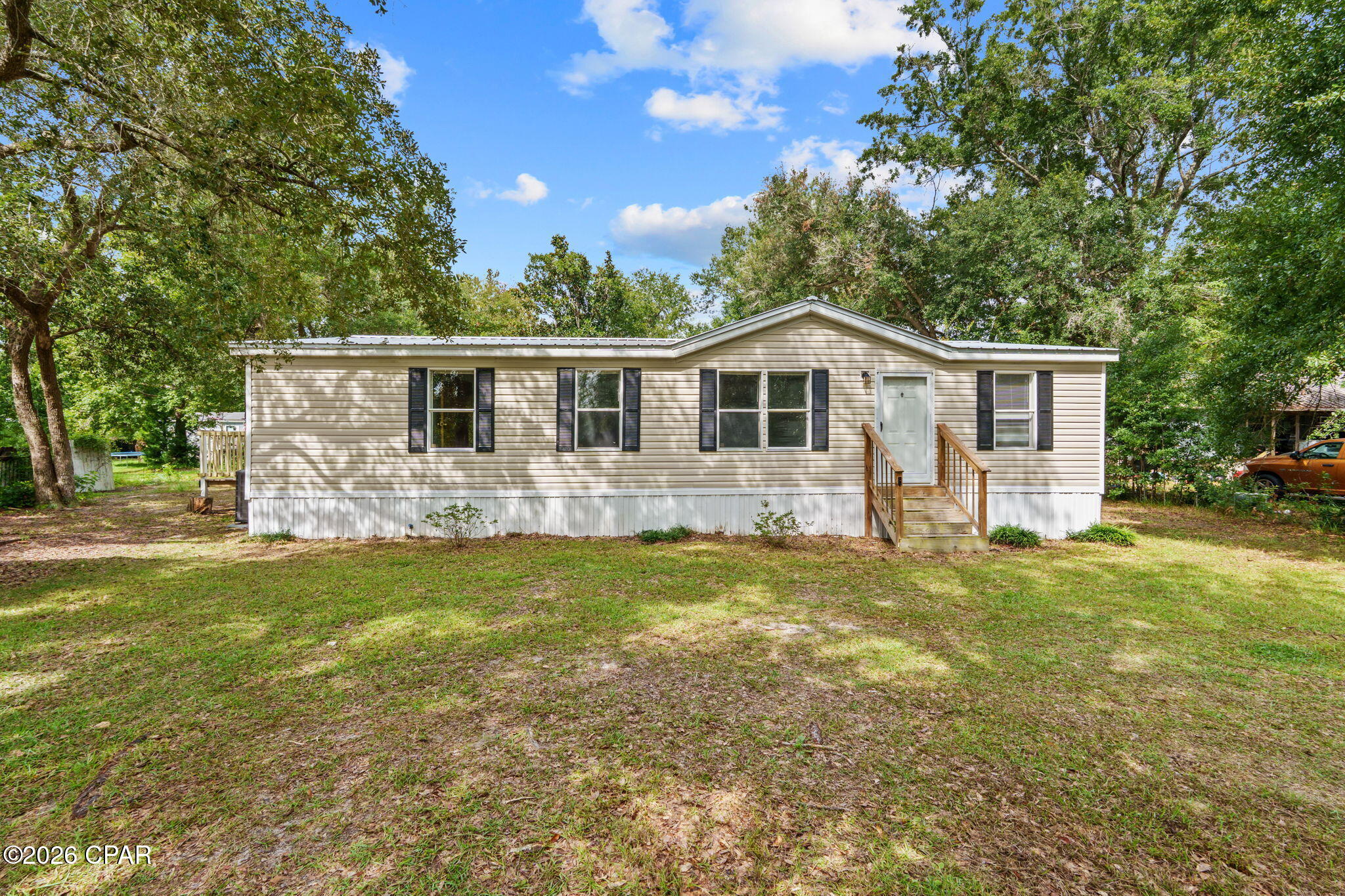 Under Contract, Seller Will Consider Back Up Offers

NEW METAL ROOF! FRESHLY PAINTED INTERIOR (pictures on MLS are prior to paint). Start your homeownership journey right here in Southport, FL. Located in the established Cedar Bluff community, this well maintained 3 bedroom, 2 bathroom manufactured home sits on approximately .86 acres and offers the space, privacy, and flexibility so many buyers are searching for. With 1,344 square feet of living space and a new roof installed in 2026, this property is move in ready with major updates already taken care of.

Inside, the open layout creates a comfortable flow between the living room, dining area, and kitchen. The kitchen offers plenty of cabinet storage, modern appliances, and ample counter space for everyday living and entertaining. The primary suite features a double vanity, garden tub, and separate shower, creating a functional private space to unwind at the end of the day.

A dedicated mudroom and laundry area lead directly to the back deck overlooking the spacious backyard. The accessibility ramp at the rear entrance provides easy access for a wheelchair, stroller, wagon, or added convenience. Outside, the nearly one acre lot gives you plenty of room for outdoor living, recreational storage, gardening, or future additions.

Additional highlights include well and septic utilities and no HOA restrictions, allowing added flexibility for how you use the property within local guidelines. Cedar Bluff is known for its larger homesites, mature trees, and convenient location in Southport. Multiple public boat launches are just a few miles away, while shopping, dining, and the beaches of the Florida Panhandle remain within a short drive.

If you have been looking for an affordable opportunity to own land without sacrificing comfort and convenience, this property is worth a look. Schedule your private showing with your REALTOR® today. All measurements and information should be verified if important.