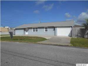 Don't miss this home!!! It has it ALL!!! Three Bedroom, Three Full Bath house within walking distance to the Gulf of Mexico. Home has been totally updated inside. Stainless appliances in the kitchen along with water filter system, composite sink, tile floors. Hardwood laminate floors throughout rest of house. Each bath features new cabinets and fixtures with tile floors. Home theatre system, LAN drops and cable connections in all bedrooms and living room, security/fire alarm system installed. Double-Pane windows, Roll-Down Hurricane shutters plus a New Roof and New HVAC (heat pump with programmable thermostat) in 2006. Transferrable Termite Bond included. The garage has a storage room with built-in cabinets. Corner lot, privacy fenced backyard with double gate for storage of boat,