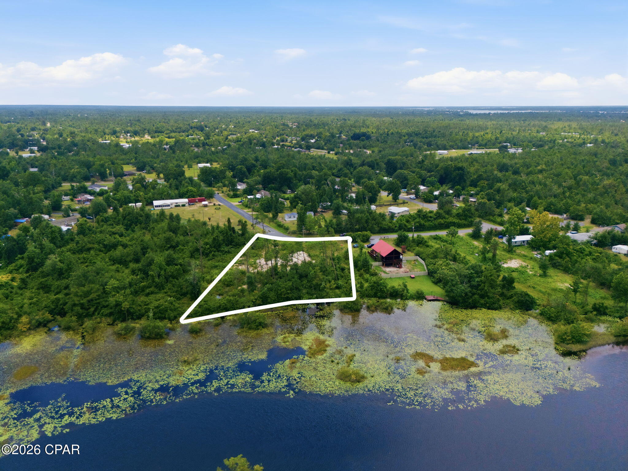 Waterfront opportunity on Bear Creek. This .775-acre residential lot at 9802 Creek Bank Drive in Youngstown, Florida, offers direct water access and serene water views in a natural setting.
Positioned along Bear Creek, the property provides an appealing setting for boating, kayaking, fishing, and other water-based recreation. With approximately three-quarters of an acre, the lot offers ample space to design and build a custom residence, subject to all applicable county and state regulations. Adding significant value and convenience, building plans are included with the lot purchase. The property is currently land-only, allowing a future owner to use the provided plans or develop an improvement strategy tailored to their needs.
The location combines a quiet, creekfront environment with access to the broader Panama City and Bay County region. Area roadways connect Youngstown to nearby services, shopping, dining, and Gulf Coast attractions, making this site suitable for a primary residence, second home, or long-term hold.
This Bear Creek lot is offered for sale as-is, presenting a rare chance to secure waterfront land with both views and direct access in a growing Northwest Florida market.