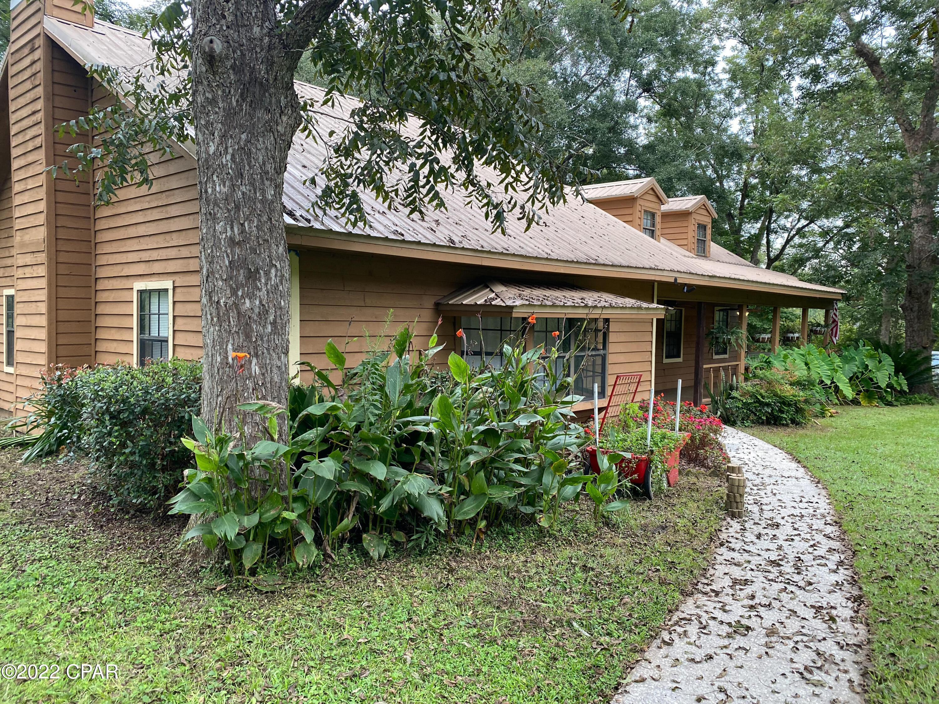 Under Contract but Taking Back UPs.  New AC installed in the last 3 week!  Large covered front porch perfect for a swing or rockers.  When you enter the front door the home has an open floor plan, large window with plenty space for your plants to get some sunshine.  Down the hallway is the laundry room,  3 bedrooms and 2 baths. The upstairs has two good size rooms and a small bathroom with stand up shower.  This would make a great teen room, office area or maybe a craft room...lots of options for this area!   The front yard is full of pecan trees and flowers. There is also a large screened porch and carport. The roof was installed in 2018 and the cedar board siding was stained in 2018.  Home is on public water, has a well and is on septic.  Come by and see this great home.