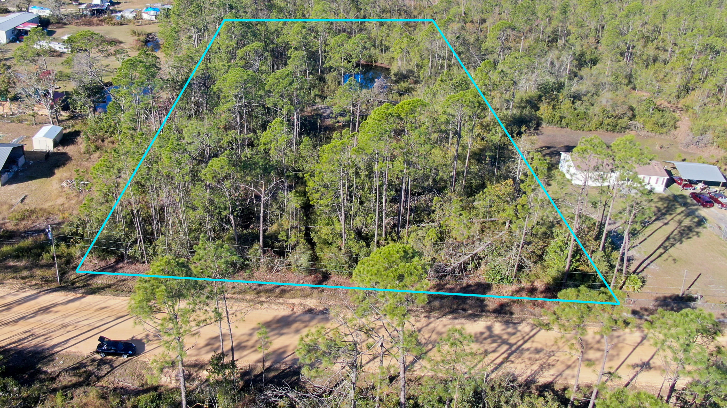 Large lot, 2.15 acres, with a stocked spring fed pond. In Southport, near Fanning Bayou. CURRENTLY UNDER CONTRACT, SELLER ACCEPTING BACKUP OFFERS.