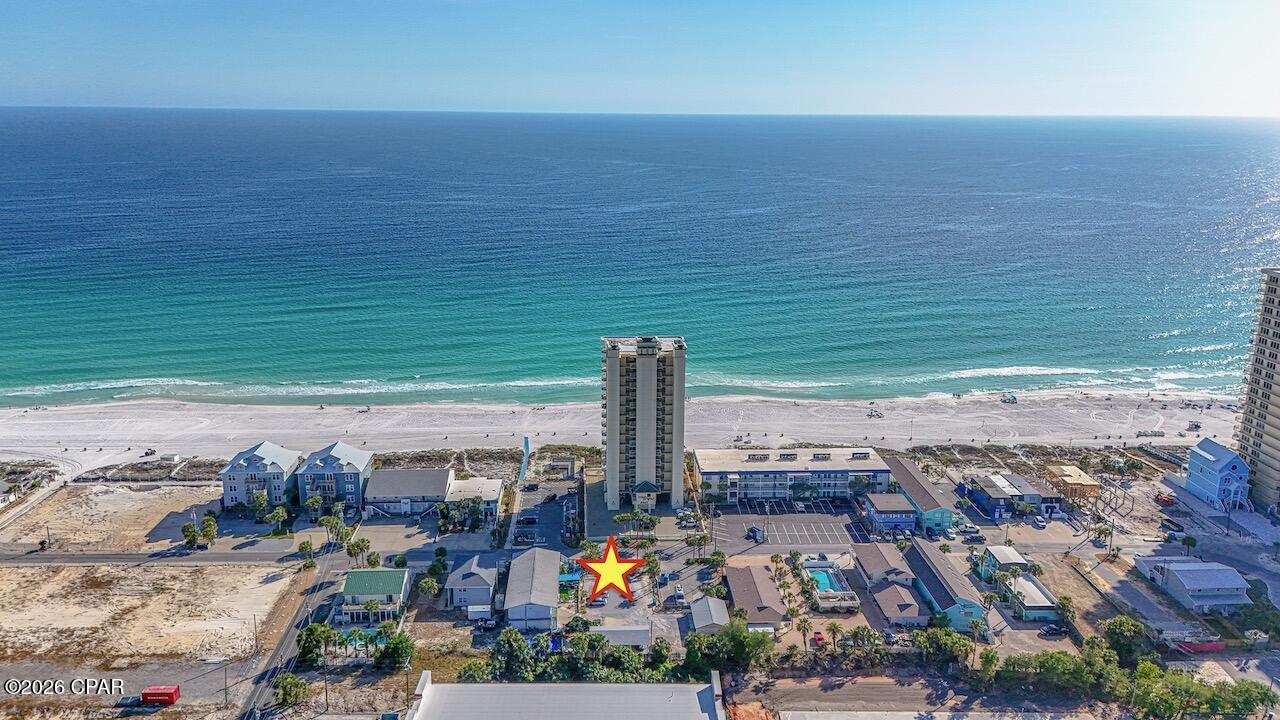 Exceptional Investment Opportunity in a Prime Beachfront Setting.  Notably, it boasts the only beach view from the north side of Surf Drive--an unmatched feature that sets it apart.  Embrace the charm of Old Florida with this rare 6-unit motel situated on over half an acre in one of the most desirable locations along Surf Drive. Rich in character and coastal appeal, this income-producing property offers a unique blend of nostalgia and modern potential.  Currently operating as a turnkey business, this thriving Bed and Breakfast is fully furnished and well maintained, providing immediate income with strong demand driven by Panama City Beach's thriving tourism market. Guests enjoy convenient beach access just steps away, along with walkable proximity to dining, entertainment, and local attractions.  The expansive lot and high-intensity zoning present exceptional redevelopment opportunities. Whether you envision expanding the existing footprint, creating a boutique lodging experience, or developing single-family or multi-family residences, the possibilities are wide open.  With its prime location, steady rental potential, and rare development flexibility, this property is an outstanding opportunity for investors seeking both current cash flow and long-term upside in a highly sought-after coastal market.