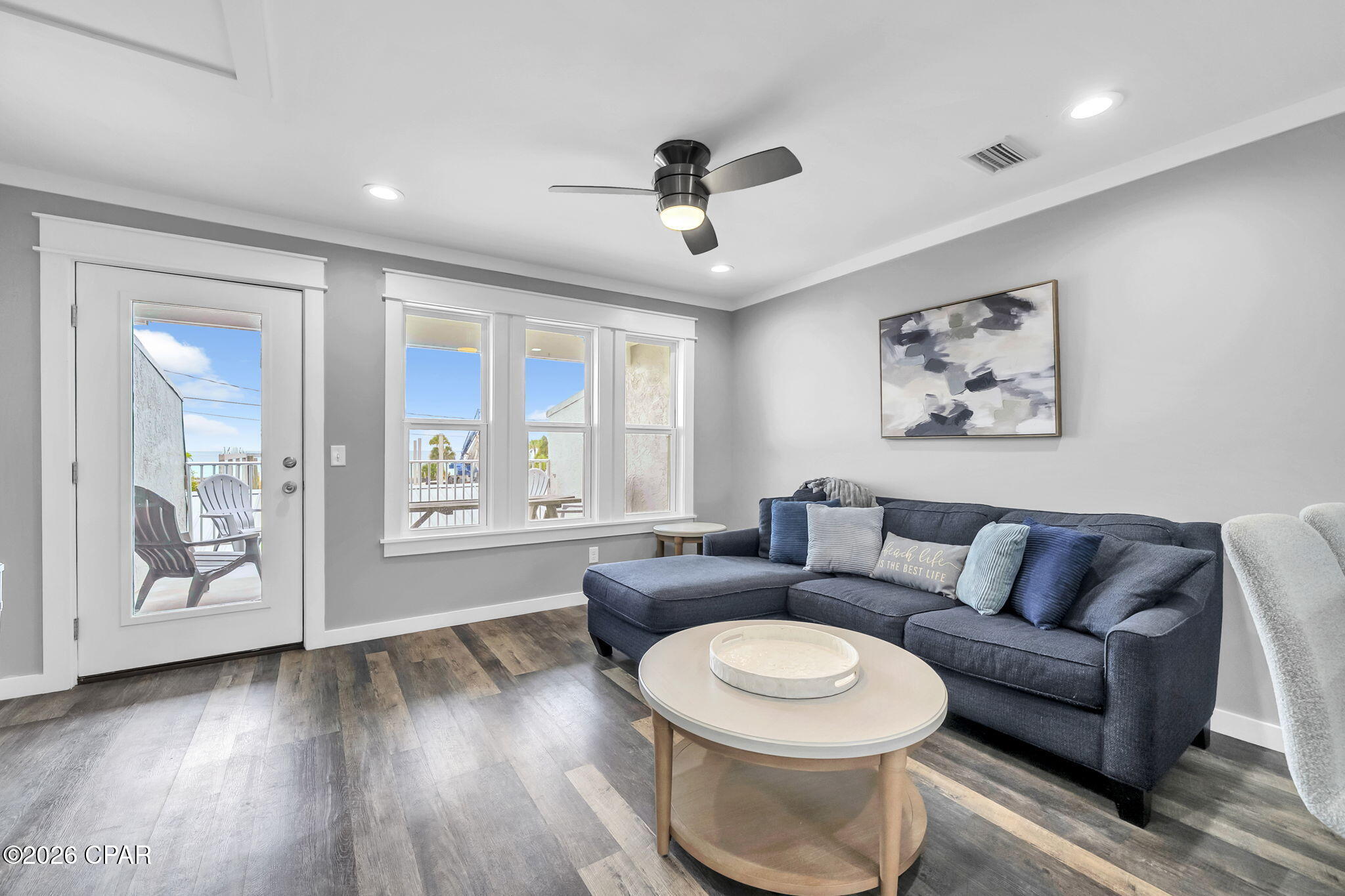 Directly across the street from the Gulf, this 2 bedroom, 2 bathroom townhome offers quick beach access, Gulf views, and updates that help reduce near-term maintenance. Two public beach access points are nearby, and the home is being sold fully furnished, making it a practical option for personal use, a second home, or rental use. For buyers exploring added rental flexibility, the neighboring townhome is also available, creating a rare opportunity to own side-by-side units.

Inside, the layout is set up to comfortably host guests with one king bed and two queen beds. The kitchen, bathrooms, and flooring were renovated in 2019, and the entire unit was freshly painted in 2025, including the walls, trim, and doors. All furnishings were also replaced in 2025, giving the interior a clean, updated feel. A full-size washer and dryer adds everyday convenience.

The living area opens to a private patio where you can enjoy Gulf views and coastal breezes. A fenced backyard provides private outdoor space to unwind after time at the beach. The home also includes a private garage for beach gear, bikes, and other coastal essentials, plus additional driveway parking for guests.

Nearby destinations include Pier Park, St. Andrews State Park, marinas, waterfront dining, shopping, and local restaurants. Buyer to verify all dimensions.