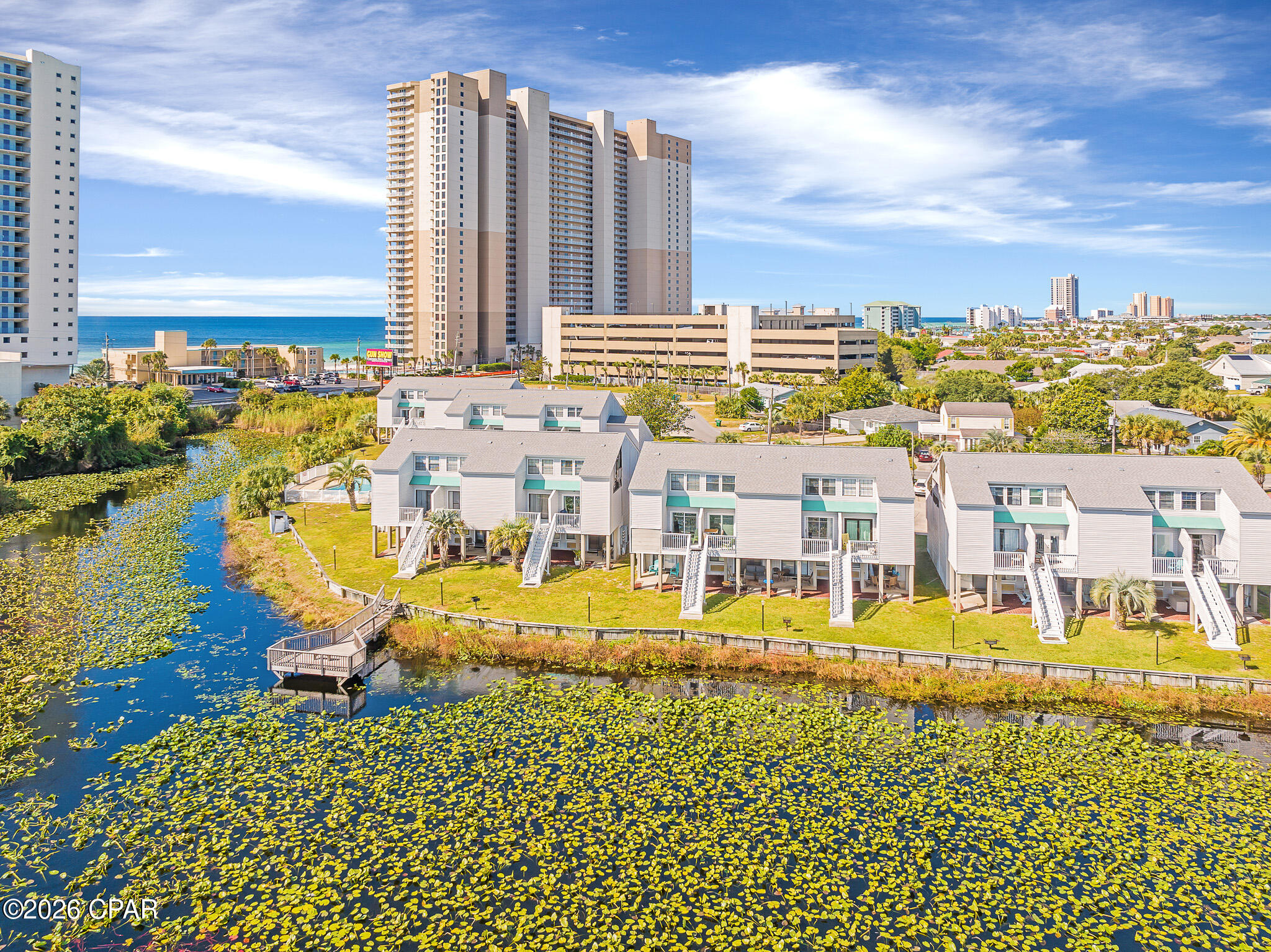 Welcome to Lullwater Beach Unit 411, ideally situated just steps away from the beach! This recently updated, freshly painted, and fully furnished 2-bedroom, 2-bath condo offers the perfect combination of coastal charm and strong investment potential. The property already has over $18,000 in secured future bookings for 2026, with projected gross rental income estimated to reach approximately $40K by the end of the year.

Tastefully furnished and rental-ready, this condo comfortably sleeps up to 6 guests and features an updated kitchen with newer appliances, luxury vinyl plank flooring throughout the living room, kitchen, and bedrooms, along with tile flooring in both bathrooms. Both bathrooms have been upgraded with beautifully tiled showers. Additional improvements include a newer HVAC system (2022), washer and dryer (2023), and water heater (2022).

Enjoy relaxing by the community pool or taking in tranquil lake views from your private back porch overlooking Lullwater Lake. Located less than half a mile from Pier Park, about one mile from Frank Brown Park, and only minutes from dining, shopping, and entertainment, this property is an excellent option for a vacation home, primary residence, or income-producing rental. The Lullwater community has recently undergone extensive exterior upgrades, including new siding, roofs, decks, and staircases. Owners also benefit from ample parking and a pet-friendly environment. This turnkey beach retreat is a fantastic opportunity in one of Panama City Beach's most convenient and desirable locations.