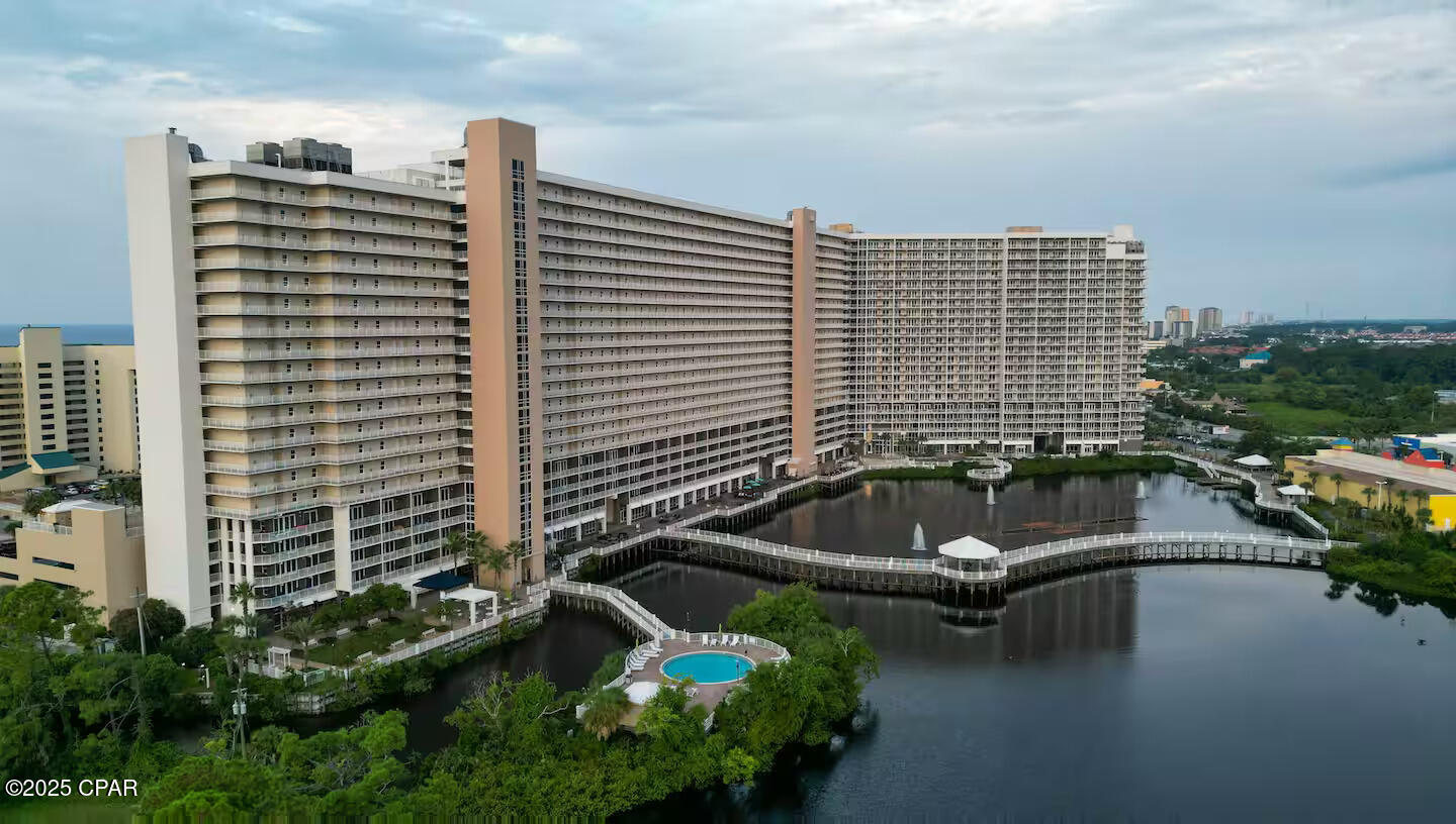 Welcome to Laketown Wharf 217! This fully furnished 1Bd/2Ba, 1,047 SqFt condo also features an additional bunk room. Perfectly located on the 2nd floor—skip the elevator and walk right in! The modern, open-concept layout boasts new LVP flooring throughout, a gourmet kitchen with white appliances, granite countertops, and a spacious living area. The master bedroom offers a peek of the Gulf, and the large private balcony is perfect for enjoying lake views and the nightly fountain show.

Now is a great time to invest in Laketown Wharf, with the exciting new addition of ''810 Billiards & Bowling''—a family-friendly venue that enhances the resort's appeal and boosts rental potential. Amenities include 5 pools (one heated), 2 hot tubs, private beach access, on-site dining, a Gulf-view fitness center, ice cream shop, hair salon, playground, multiple elevators, 2 covered parking garages, a boardwalk over the lake, doggie area, and more.

Whether you're looking for a primary residence, vacation getaway, or income-producing property, this condo is a must-see. Schedule your private showing today!