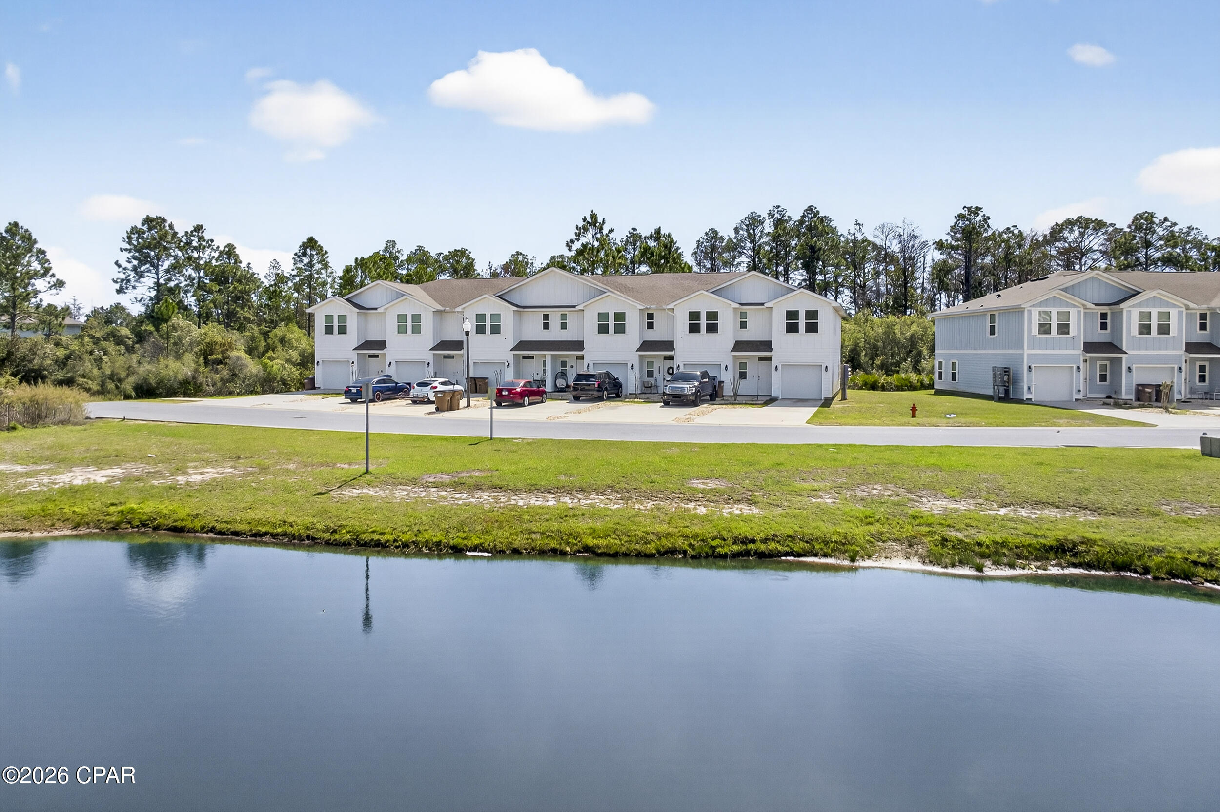 Enjoy the best of Panama City Beach living in this beautiful 3BR/2.5BA corner unit residence in the desirable Hathaway Townhomes on the east end of the city. Just minutes from the Navy Base, Publix Sports Park, and the Gulf's white-sand beaches, this location makes commuting, recreation, and weekend escapes effortless.

The bright, open first floor features a welcoming living and dining space with 10' ceilings and a designer lighting package that enhances the airy, spacious ambiance. The kitchen flows seamlessly from this space and offers granite countertops, stainless steel appliances, custom cabinetry, and a water filtration system. A convenient half bath is located just off the kitchen. Modern convenience and security are built in with a Smart Home package, including keyless entry, Skybell doorbell, automated front porch lighting, an Echo Dot, and a Quolsys touch panel for controlling lighting, doors, thermostat, and more.

Upstairs, the primary suite includes a walk-in closet and private ensuite with a luxurious shower, while two additional bedrooms share a well-appointed bath, providing comfortable and private space for family, guests, or a home office. A one-car garage provides secure parking and storage, with additional driveway space for multiple vehicles.


The community offers a resort-style pool and fully maintained landscaping, with the HOA covering personal lawn care, trash service, and upkeep of common areas, giving you a low-maintenance lifestyle. Pets are welcome and short-term rentals are allowed with a one-week minimum, making this townhome a flexible option for both personal living and investment potential.