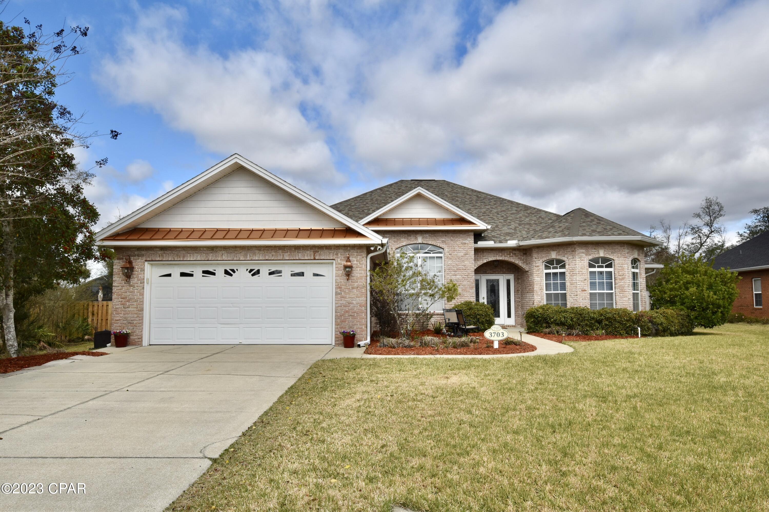 Beautiful 4 bedroom 3 bath custom pool home with detached workshop/garage in the community of Grant's Mill I in Lynn Haven. 2,811 sq ft heated and cooled; 3,855 sq ft under roof! Only minutes to some of the best charter and public schools, restaurants, shopping, as well as Lynn Haven parks w/public boat ramps. This custom home includes many architectural details, a great floor plan, plenty of storage, a large detached heated and cooled 18' x 14' workshop (slab on grade) and 28' x 14' heated saltwater pool! As you enter the home, you notice a double tray ceiling in the living room highlighted by crown molding, as well as a mantel and electric fireplace.  The formal dining area also features a double tray ceiling, 36'' x 6'' tiles, and chair rails. The kitchen is the heart of this home and ready for any home chef, boasting a GE double oven, GE microwave, as well as a GE CAFE (hot water) 3-door refrigerator, and a KitchenAid dishwasher. The custom wood cabinetry includes 40" tall cabinets w/lighting, and the flooring has 18" tiles. 

The office entrance is highlighted by a custom transom, plantation shutters, and includes a bookcase and desk.  It could also be used as a fifth bedroom.  The master bath features split vanities, garden tub/spa, separate water closet, and tiled shower.  Bathroom 2 is a shower/tub combo, tile floor, linen closet, and double vanity.  Bathroom 3 is a shower only with door leading to Florida Room and Pool.  The 324 sq ft Florida Room includes its own heating and cooling unit (not a part of the main living area), and has a great view to the backyard and pool area.  

The 2019 in-ground gunite salt water pool includes custom tile work and a sun shelf; in addition it uses a heat pump to extend your pool season! The pool area is lined with pavers/coping pavers and includes a security safety screen that outlines the pool perimeter ensuring the safety of pets and family.  Off to the side of the pool area is a large 18' x 14' heated/cooled, powered (75 amp) garage/workshop!  This offers endless opportunites beyond a workshop, such as parking space for small recreational vehicles, golf cart, or simply have your own climate controlled storage building.   Heating and cooling units are seperate from main home.  Yard includes irrigation and is fully fenced in. The attached finished 2 car garage also has pull down stairs for storage above, and a quiet belt driven Ryobi Garage Door Opener that includes a BT speaker, fan, and parking laser. 

Although this home is in Lynn Haven, it's considered to be Bay County unincorporated, which translates to a lower millage rate and lower taxes! This home is a hidden gem and a must see to truly experience all it has to offer! All measurements are approximate and should be verified if important. Schedule your showing today, this beautiful home is ready for its new owners.