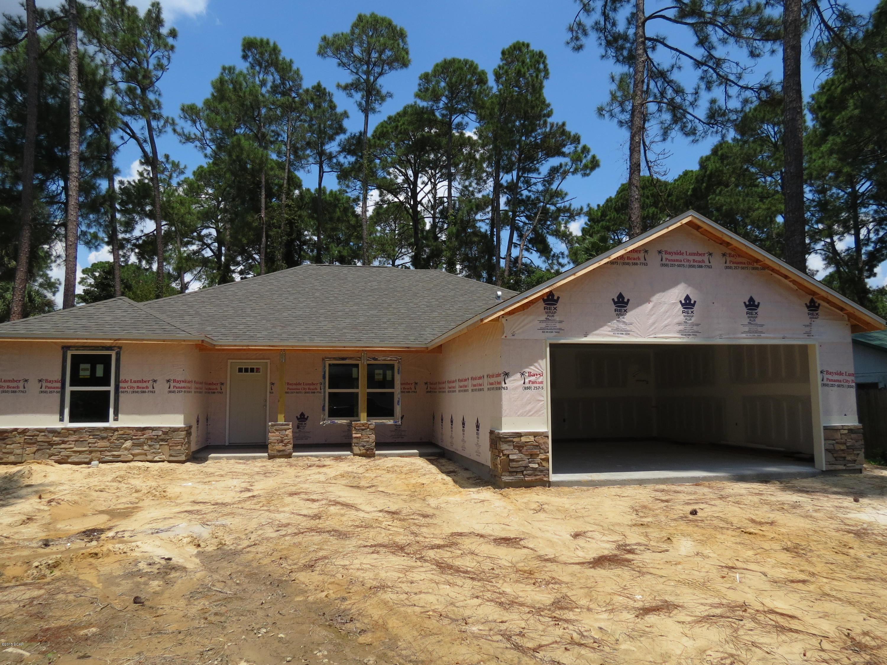 If you are looking for a brand new 4 bedroom, 2 bath home on a good sized lot, in a nice, quiet neighborhood in Panama City Beach, look no further! This beautiful, custom built home is designed with a split bedroom plan w/ very large rooms. This home sits on a large 75 x 120 lot and has many great features and upgrades. As you enter the front door, you will notice the large 10ft ceilings in the living room, formal dining room, and spacious kitchen. The kitchen has lots of counter space w/ a breakfast bar, beautiful cabinets, tiled backsplash, and granite counter-tops. The kitchen also offers a nice 4 piece stainless steel appliance package to include a side by side refrigerator, stove, microwave and dishwasher. There is also an eat in breakfast area over looking the backyard. Beautiful porcelain, brick laid, 12x24 tile can be found throughout the living room, formal dining room, kitchen, laundry room and bathrooms. All 4 bedrooms have high quality frieze carpet. The master bedroom is very spacious w/ boxed ceilings, and a very large walk-in closet. The master bathroom offers a 72 inch double vanity w/ granite counter top, a large garden tub to enjoy a relaxing bath, and a separate tiled shower. The 3 additional bedrooms are located on the other side of the home and each offer lots of room to handle large furniture w/ spacious closets. There are many other desirable features to include: A large two car garage, all electric central heat and air, separate laundry room, manicured yard with irrigation system, and large covered, back and front porch areas. This terrific home is centrally located on the beach, close to the beautiful beaches, Pier Park, and many restaurants! You definitely want to put this on your list of homes to see today! Home should be completed by the end of September 2015.Builder is offering a 1 year builder's warranty that is transferable.