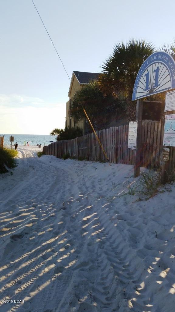 Steps to the beach and no association dues! This 2 bedroom 1.5 bath townhome has been remodeled and furnishings are included.  Brand new A/C unit, refrigerator, stove, carpet, paint, etc. Step outside the French doors to a large privacy fenced back yard with extra storage closet. Buyer to verify measurements. Owner is a licensed FL agent.