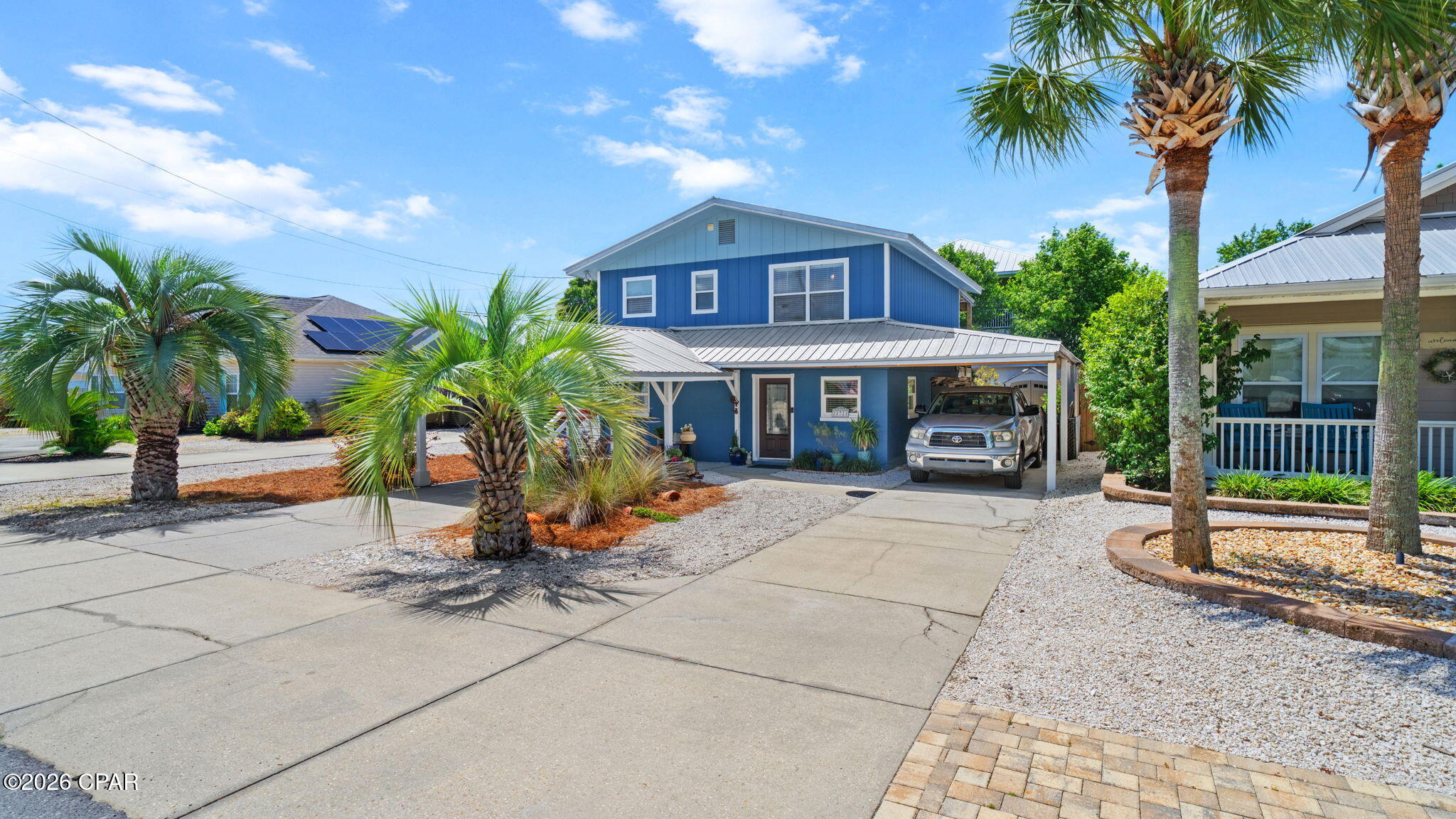 RARE OPPORTUNITY with this Riviera Beach home just a few blocks from the Gulf!  Riviera Beach is a short term rental friendly neighborhood.  This 3BR/2BA home with a living room and kitchen on each floor.  The layout of the home is also unique in that there are two separate main entrances one downstairs and one upstairs. It would be easy to close off the second floor to live in & then rent out the entire first floor since short-term rentals are allowed or allow a wonderful inlaw suite.  The upstairs kitchen has  granite counters &  stainless steel appliances, & all of the flooring is Luxury Vinyl Plank.  The downstairs kitchen is complete with a eat in area. The large backyard is a gardeners dream with gorgeous plants, a fire pit and lots of entertaining space on the large upstairs deck. The downstairs patio is accessible from the home and allows another large entertainment space.   There is a carport over a portion of the large parking area with room for cars and a golf cart.  The roof, A/C and water heater are all newer, making this a sound investment.  Make your appointment today to see this beach beauty!